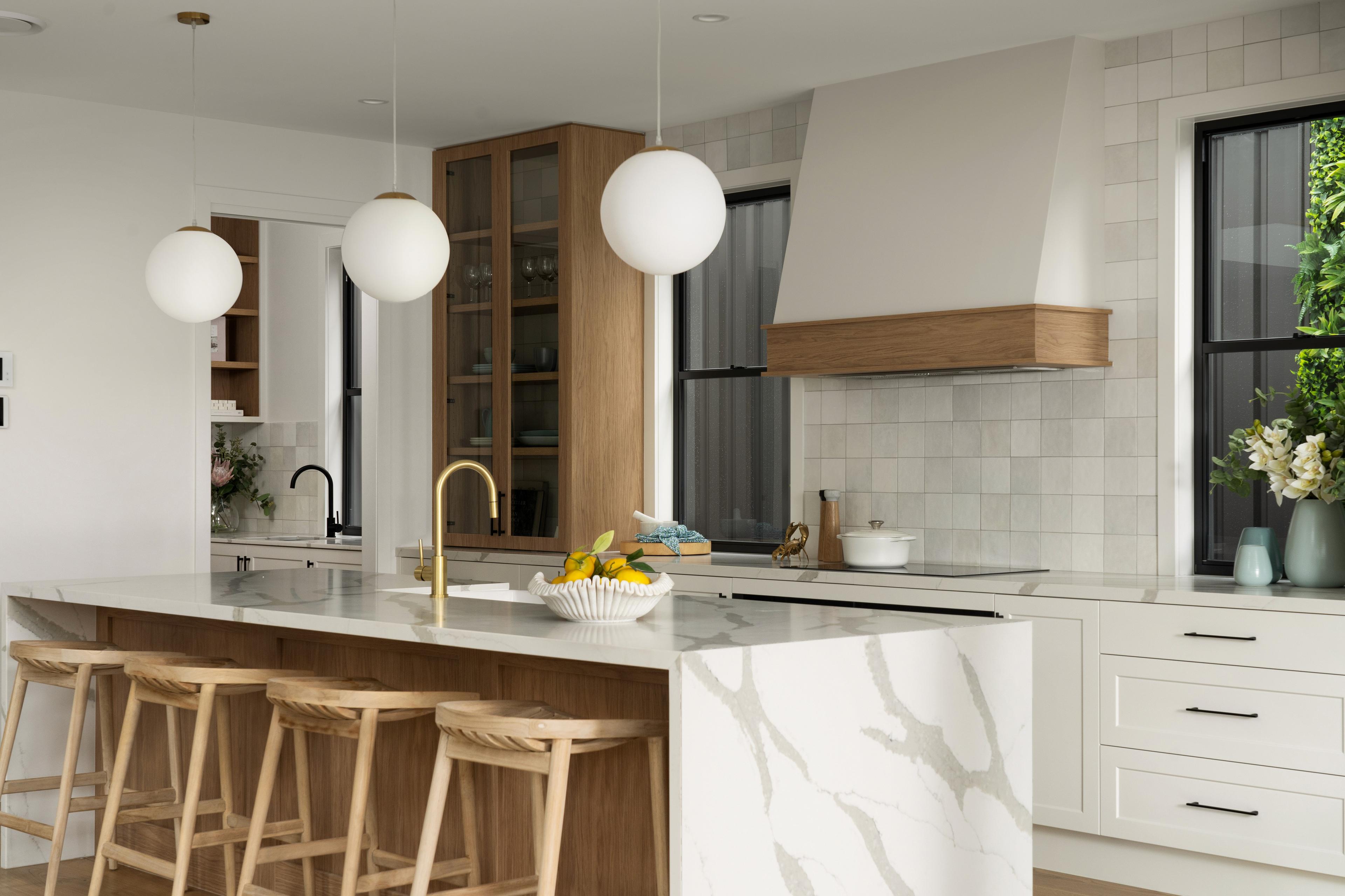 Kitchen with marble island, timber joinery and pendant lights