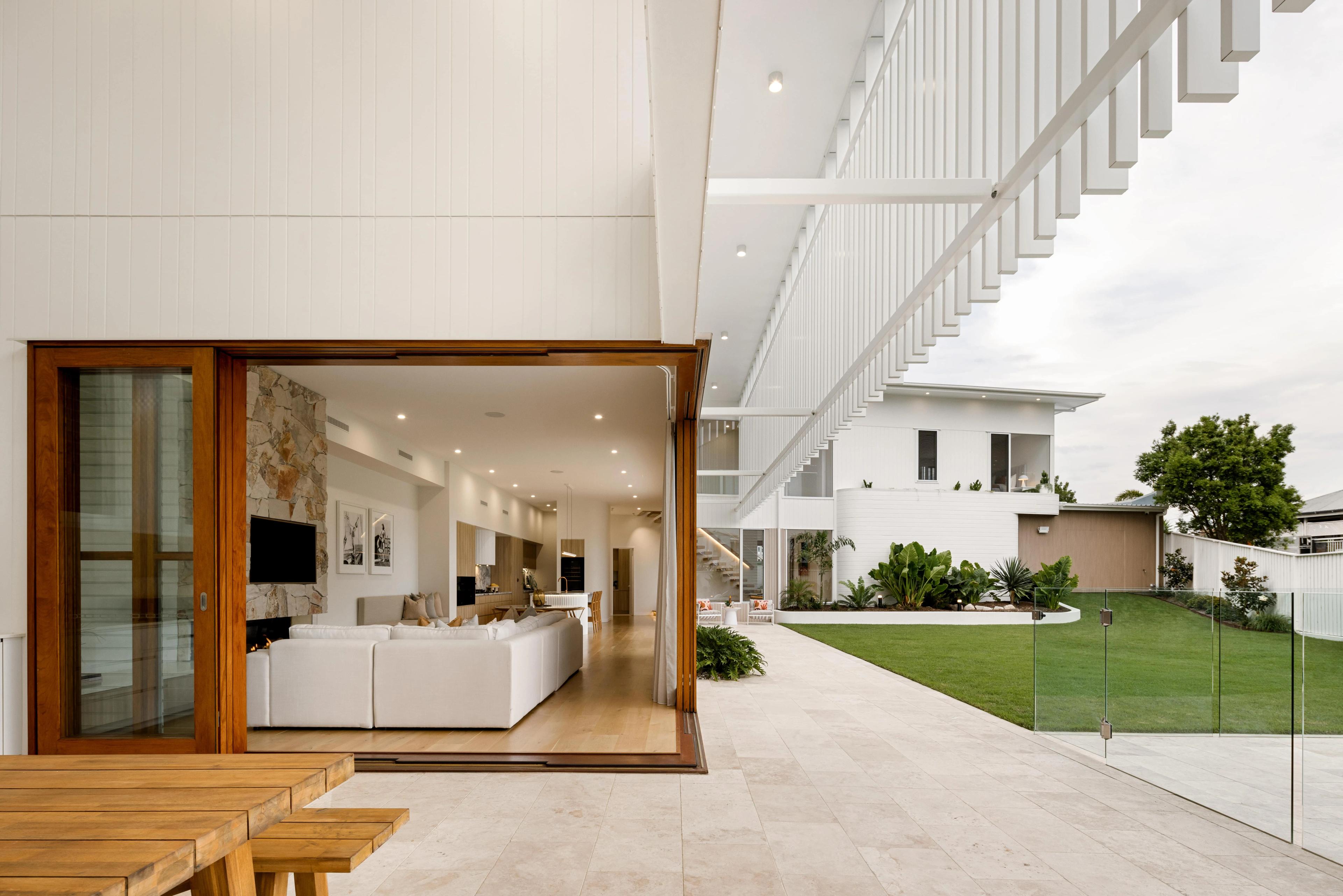 Covered terrace looking out to lawn and pool courtyard