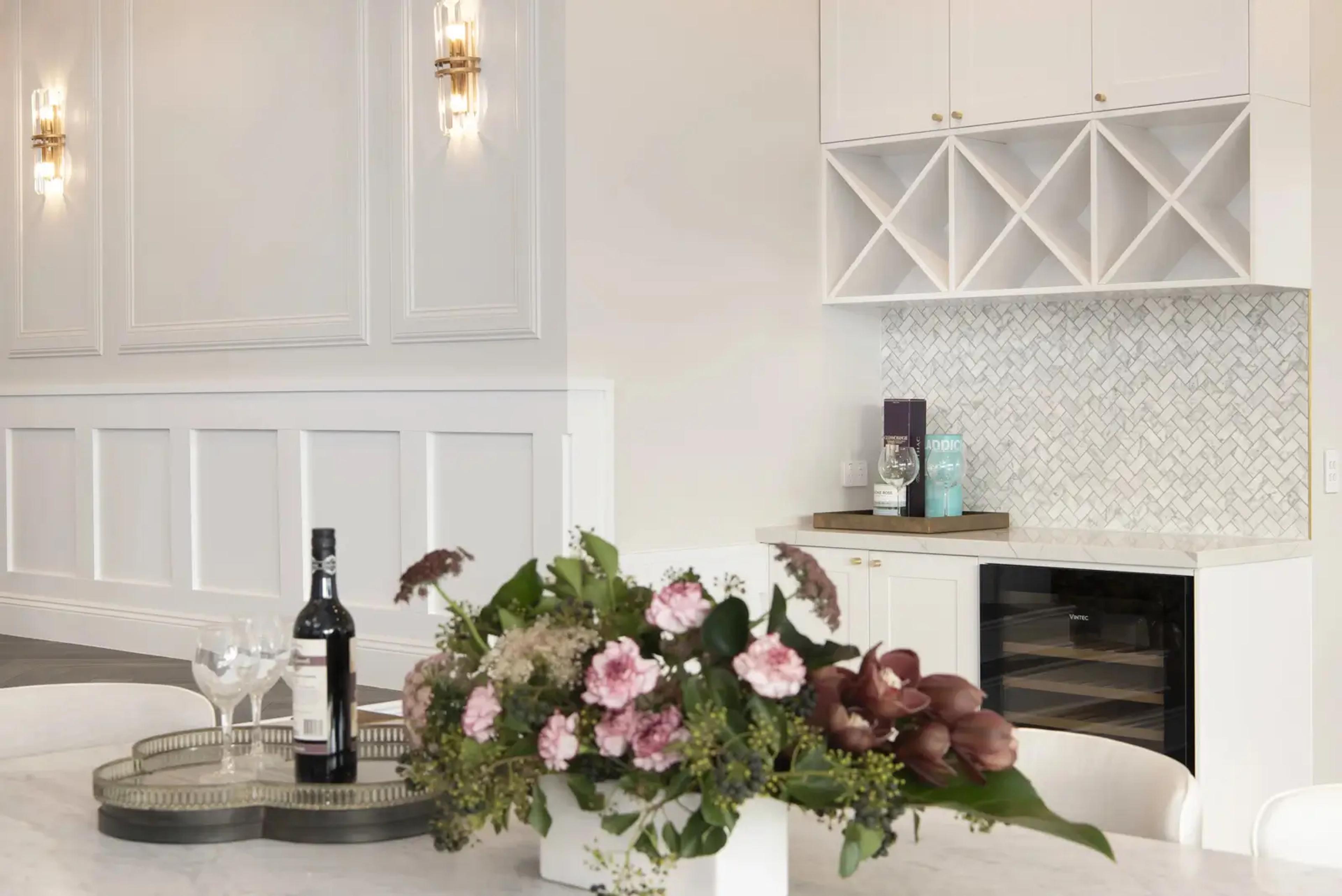 Butler pantry with wine rack, mosaic splashback and beverage fridge