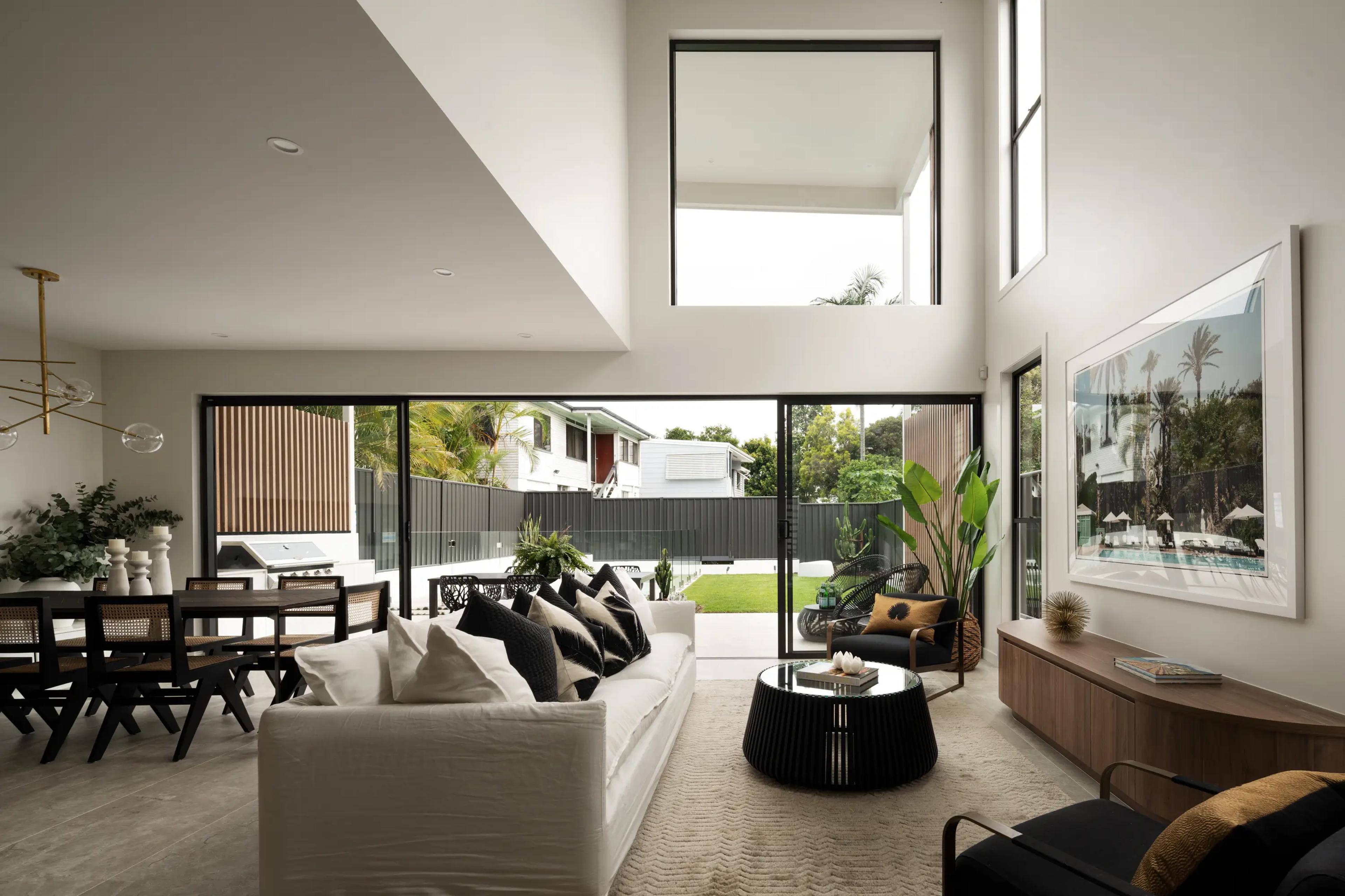 Double height living room opening to backyard pool