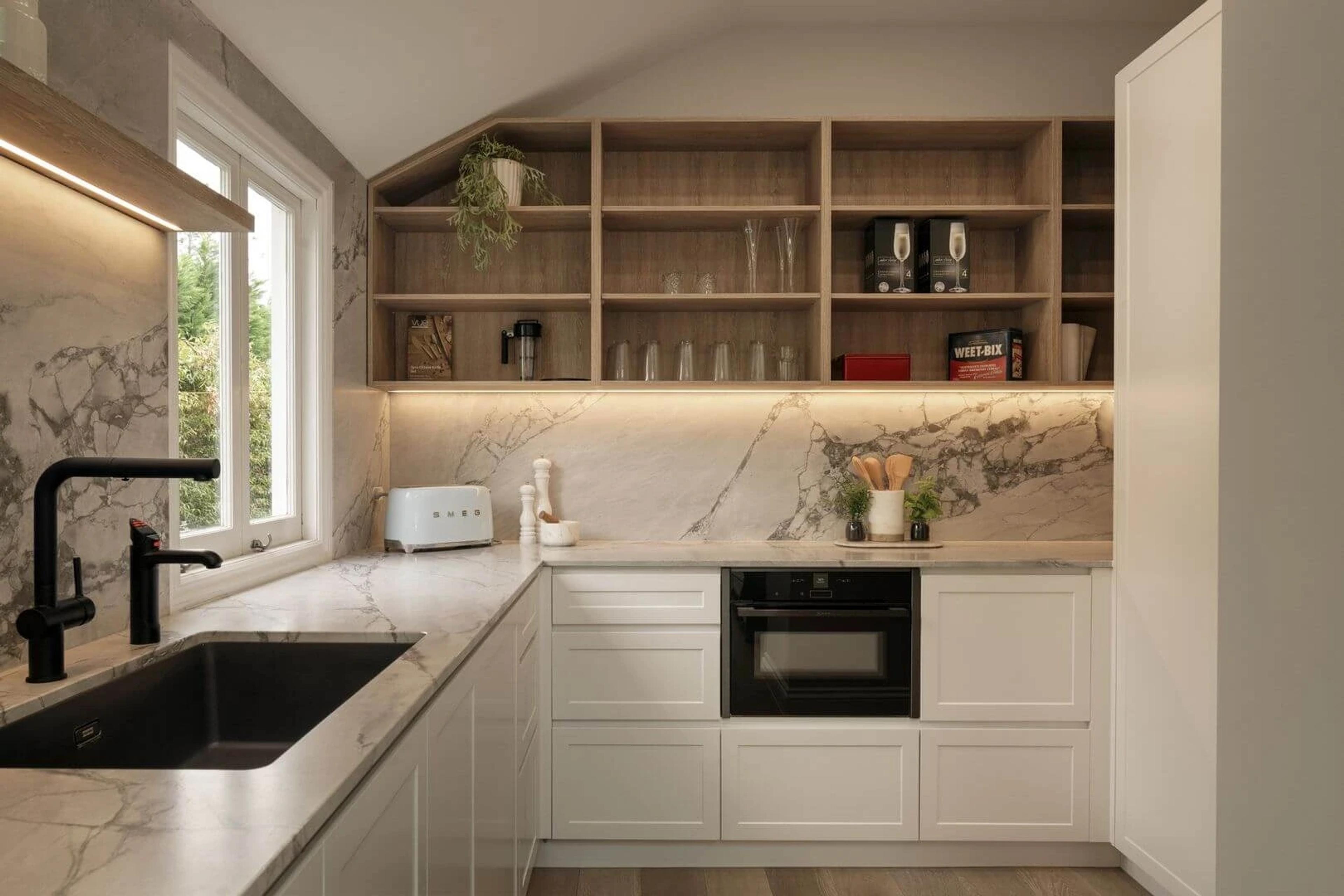Butler's pantry with marble bench, black tap and open timber shelving