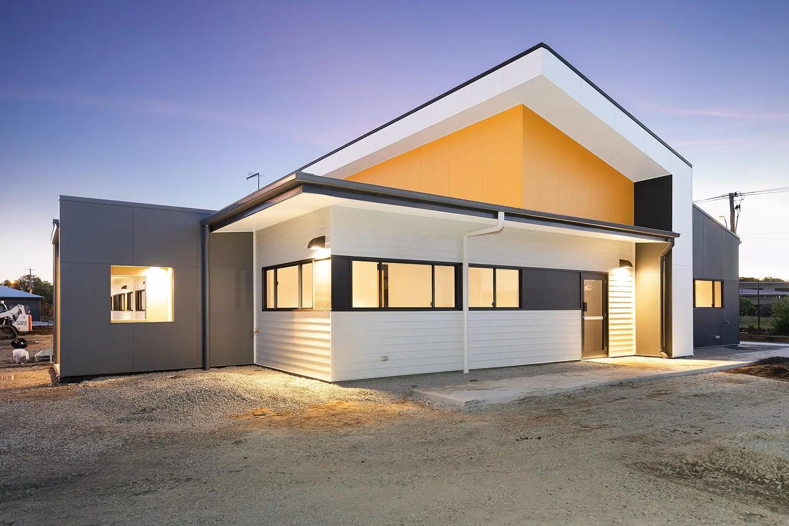 Twilight exterior of commercial office building with covered entry