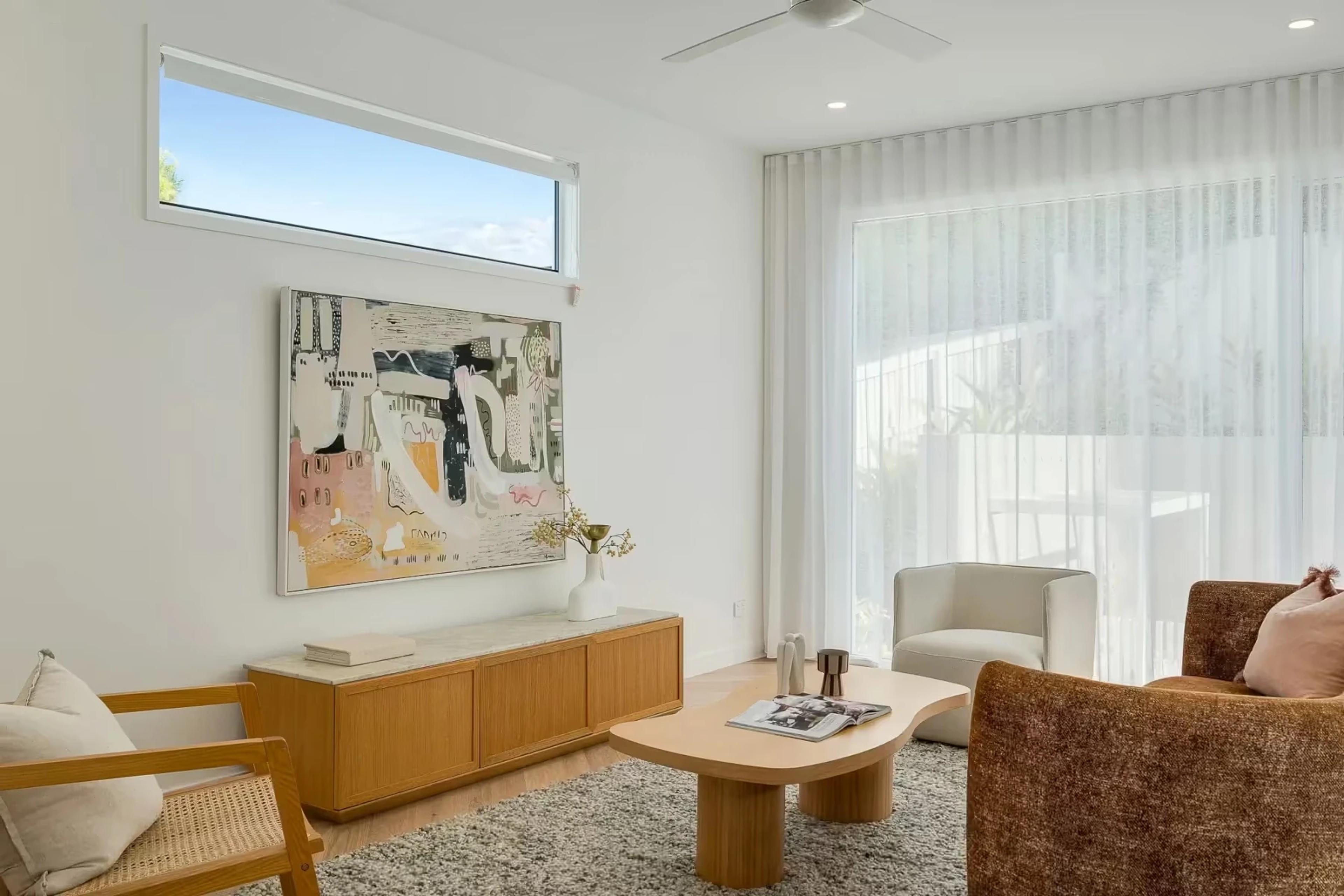 Living room with artwork and sheer curtains