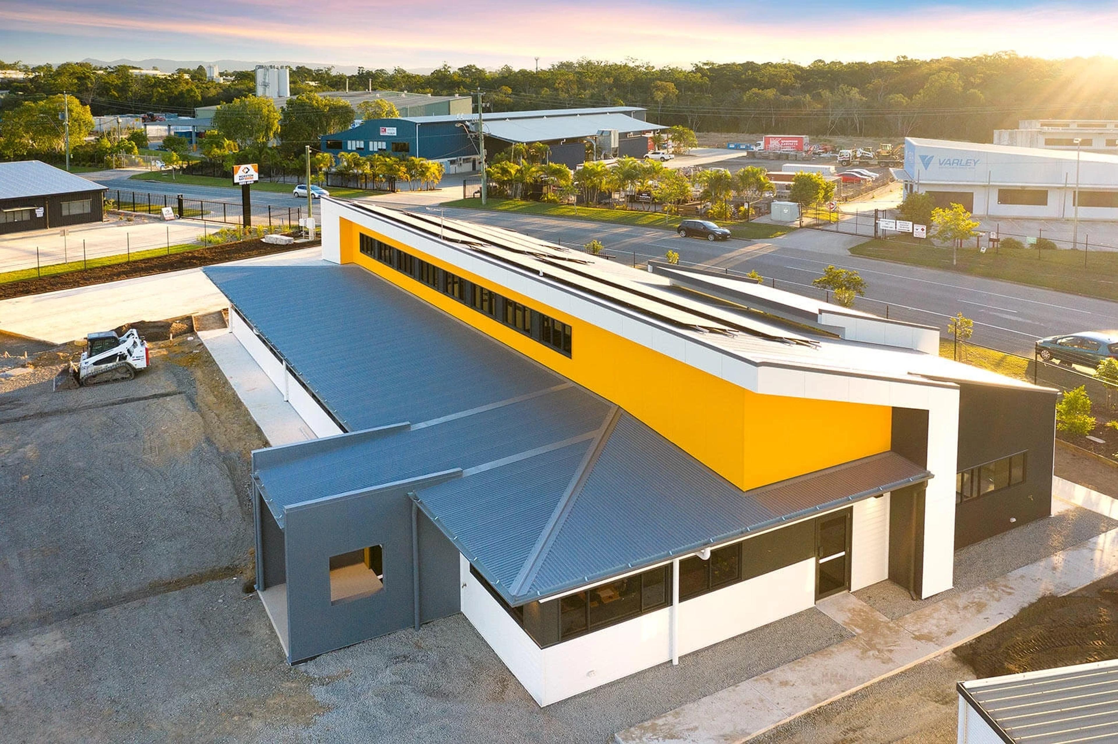 Aerial view of office building and industrial estate at sunset