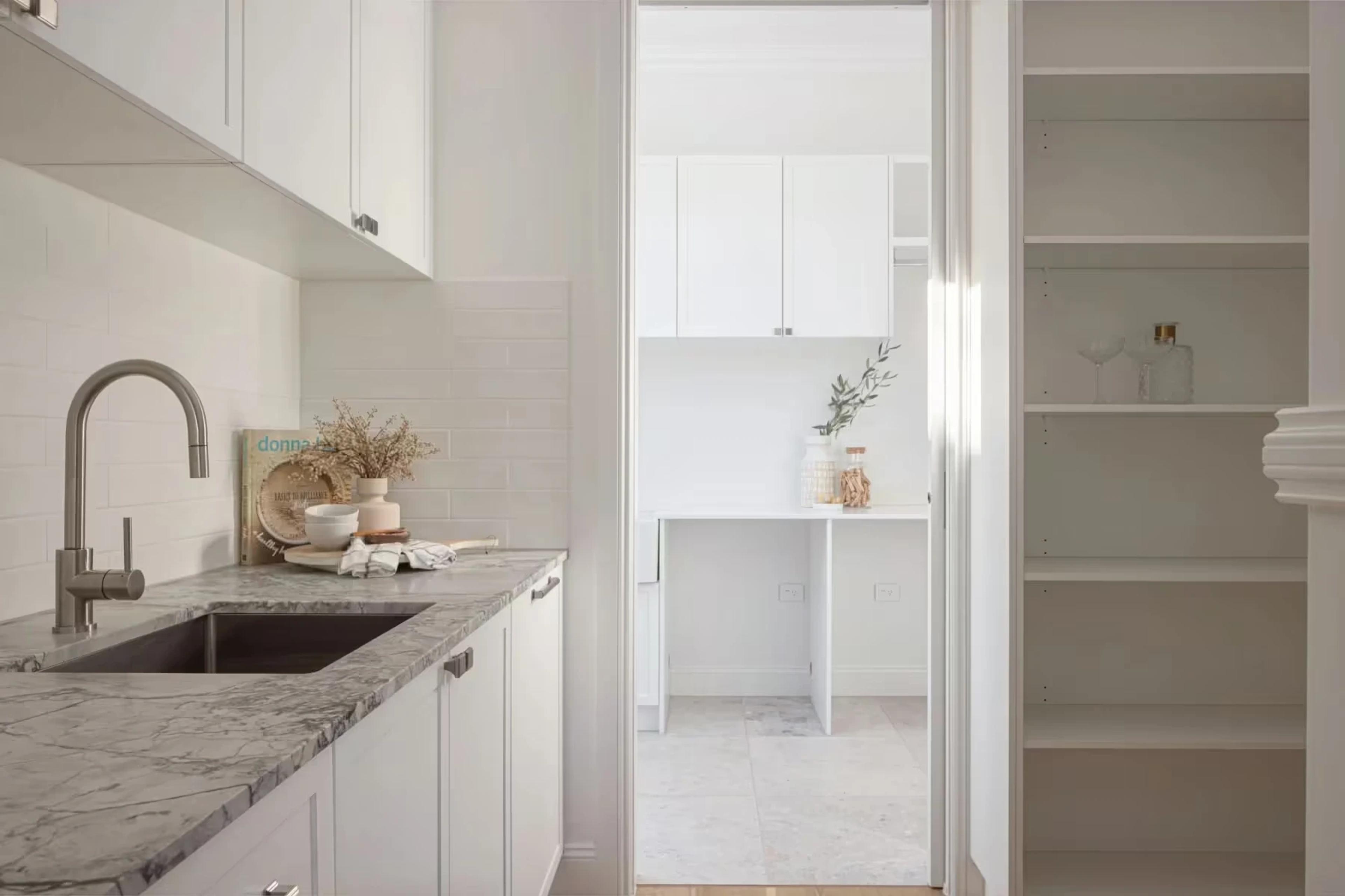 Butler pantry with stone benchtop, sink and open shelving