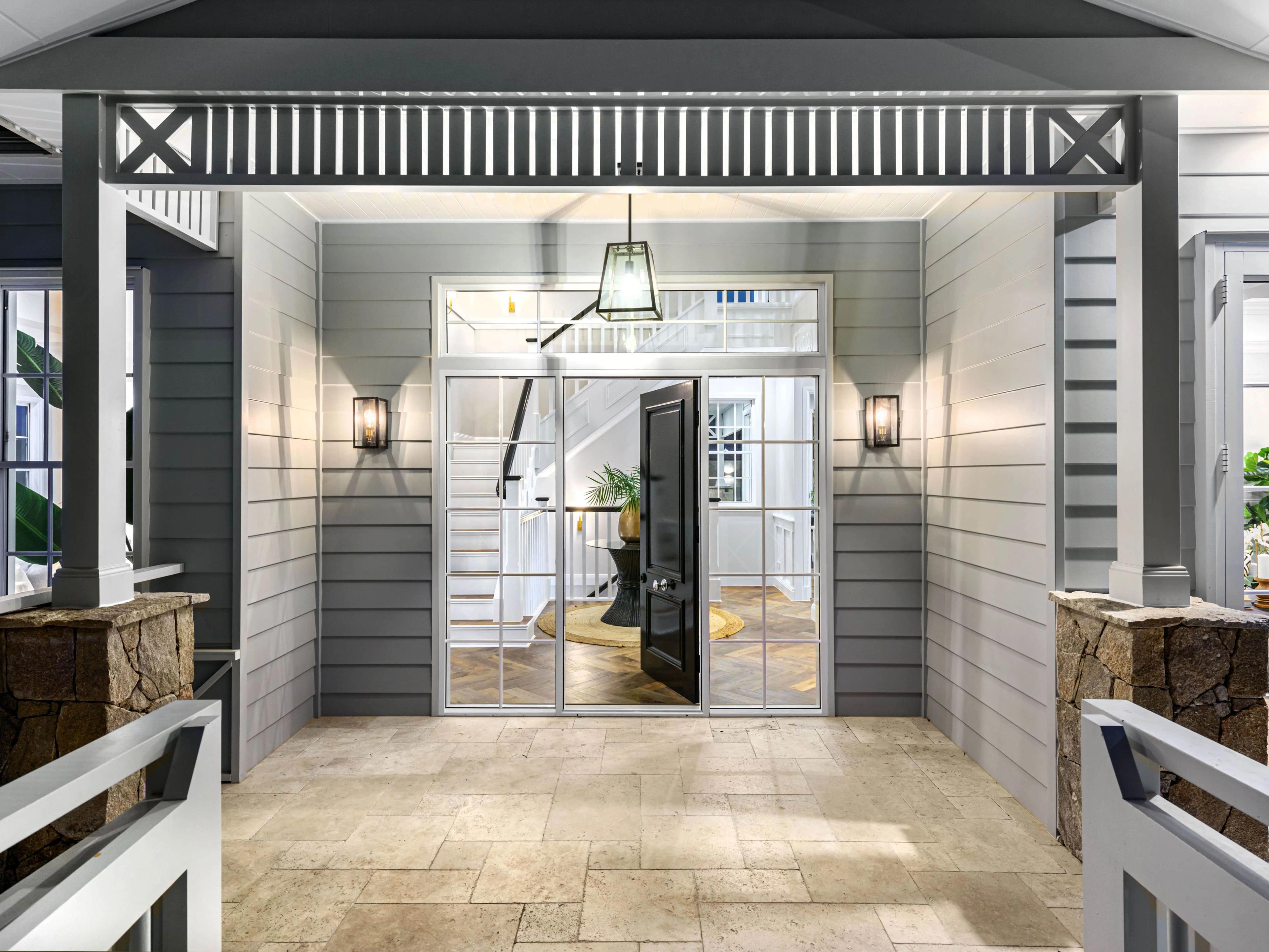 Covered front entry porch with black glazed doors