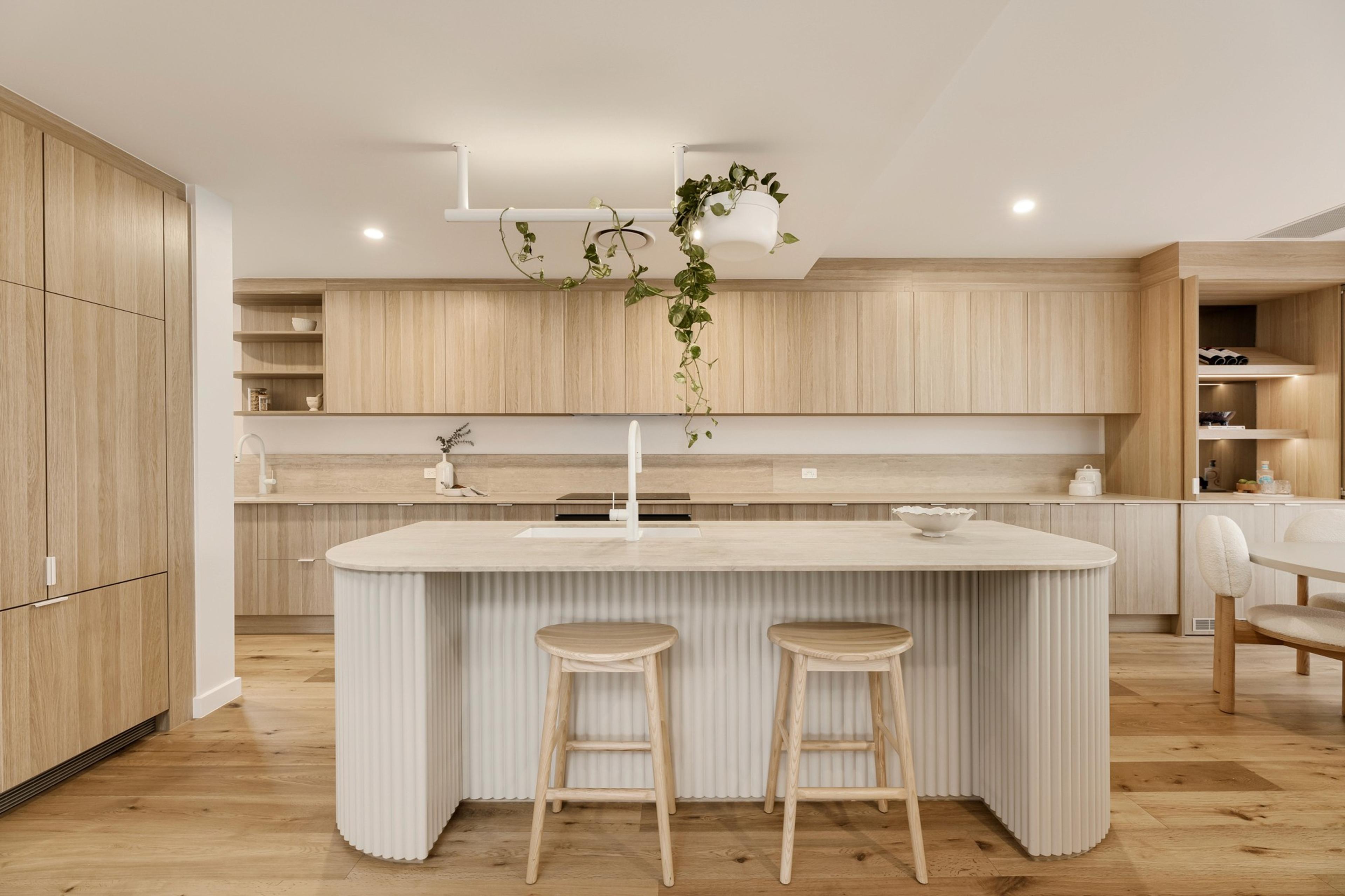 Fluted kitchen island with stone benchtop and timber cabinetry