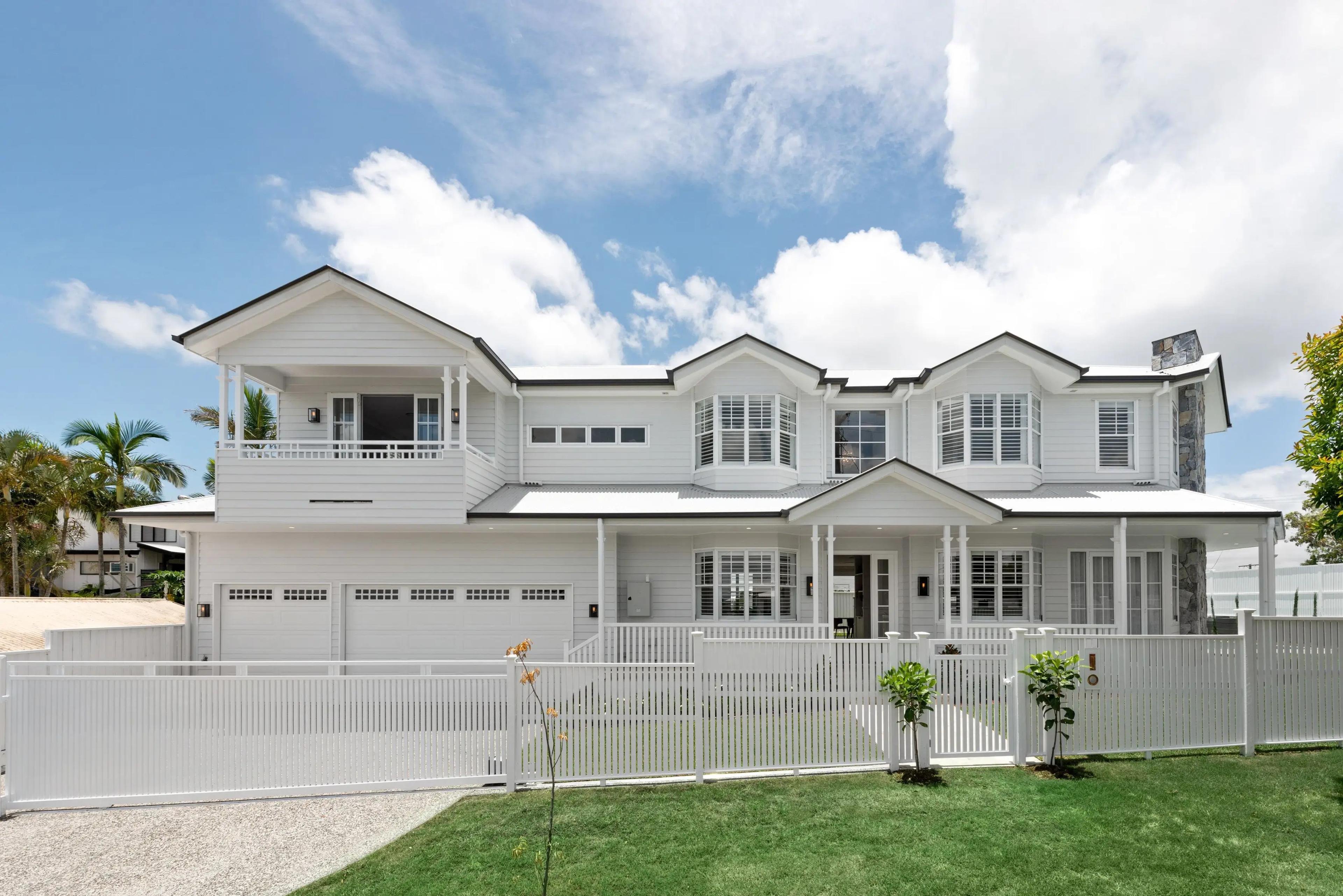Front facade of two storey white Hamptons style home with garage