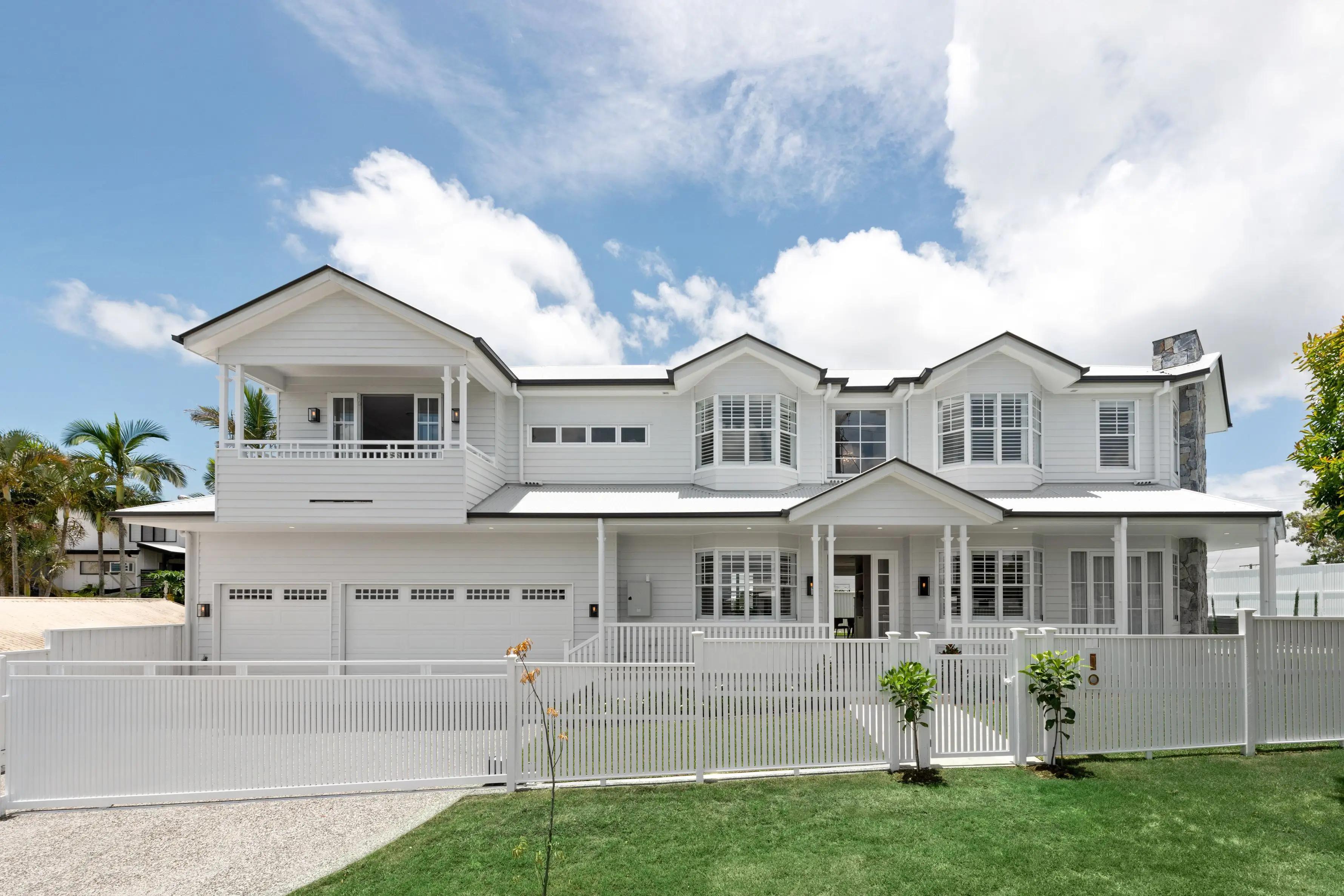 Front facade of two storey white Hamptons style home with garage