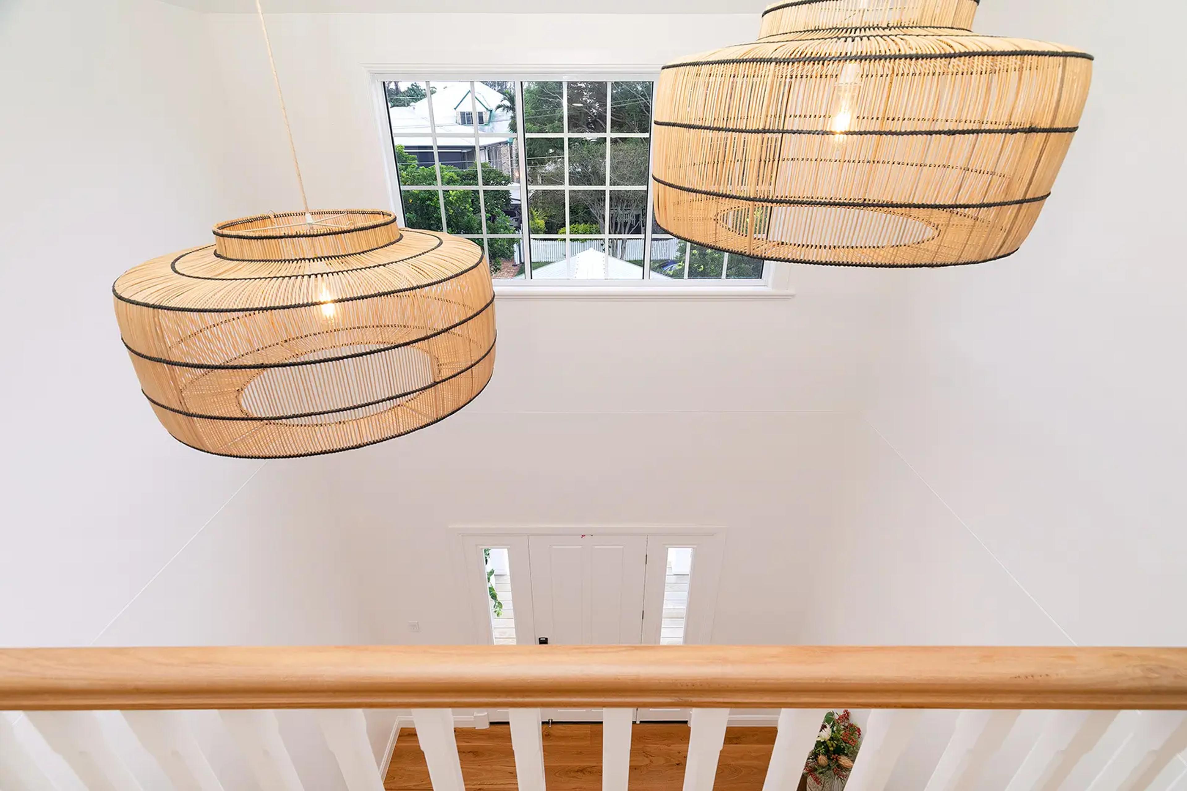 Stairwell landing with rattan pendant lights and window