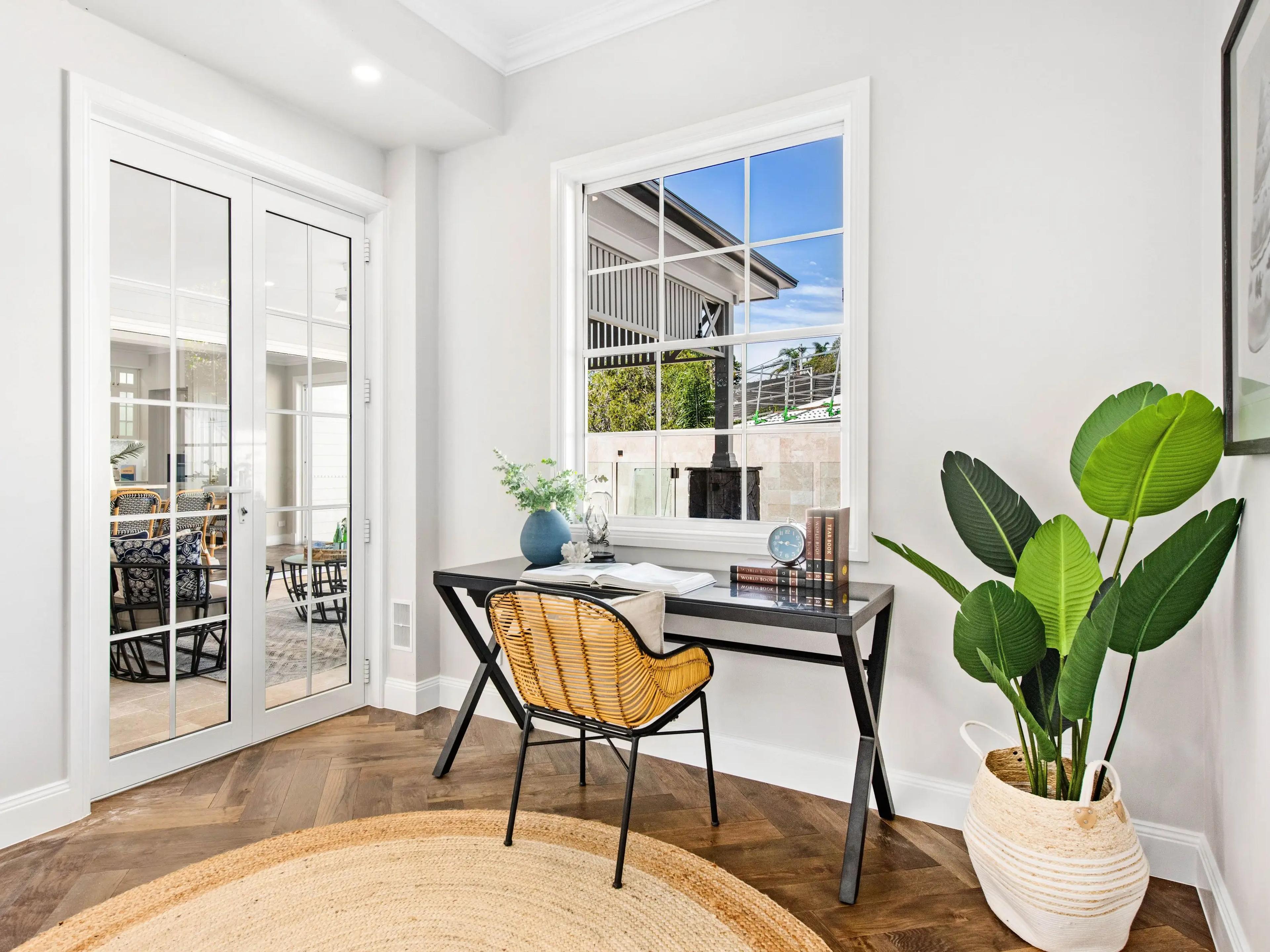 Study nook with desk beside glazed French doors