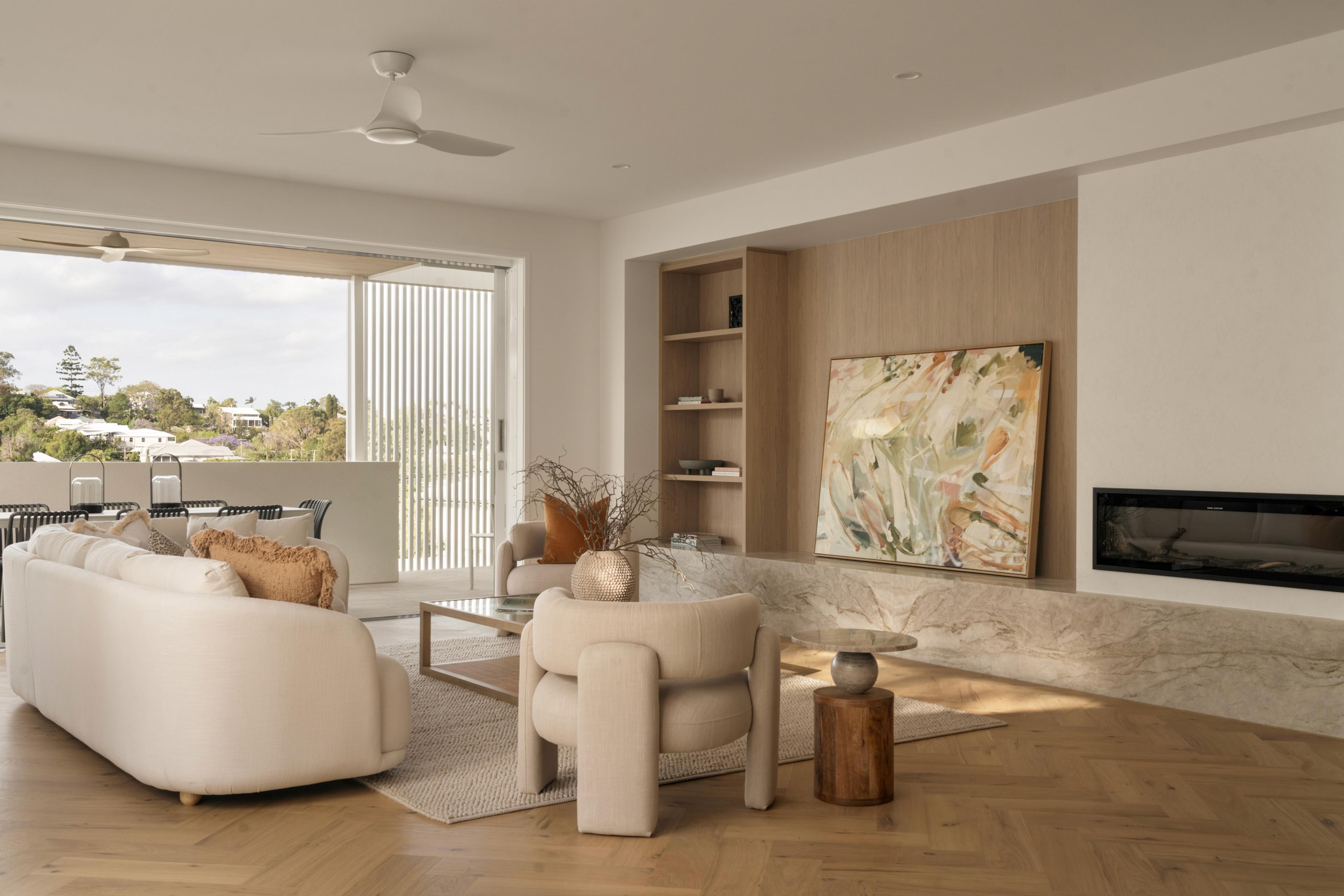 Living room with curved sofa and leafy outlook