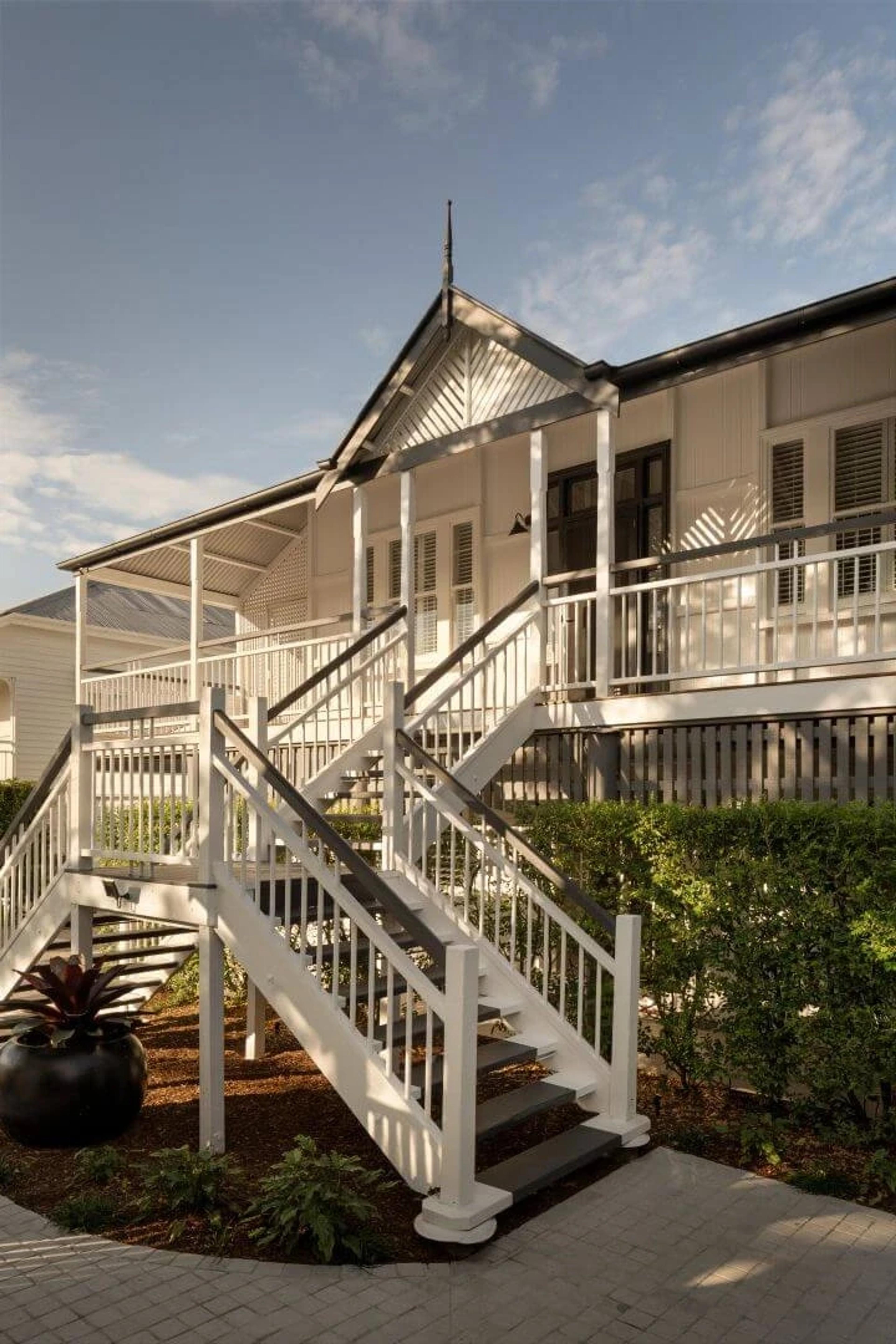 Timber verandah stairs and railings on a white timber home