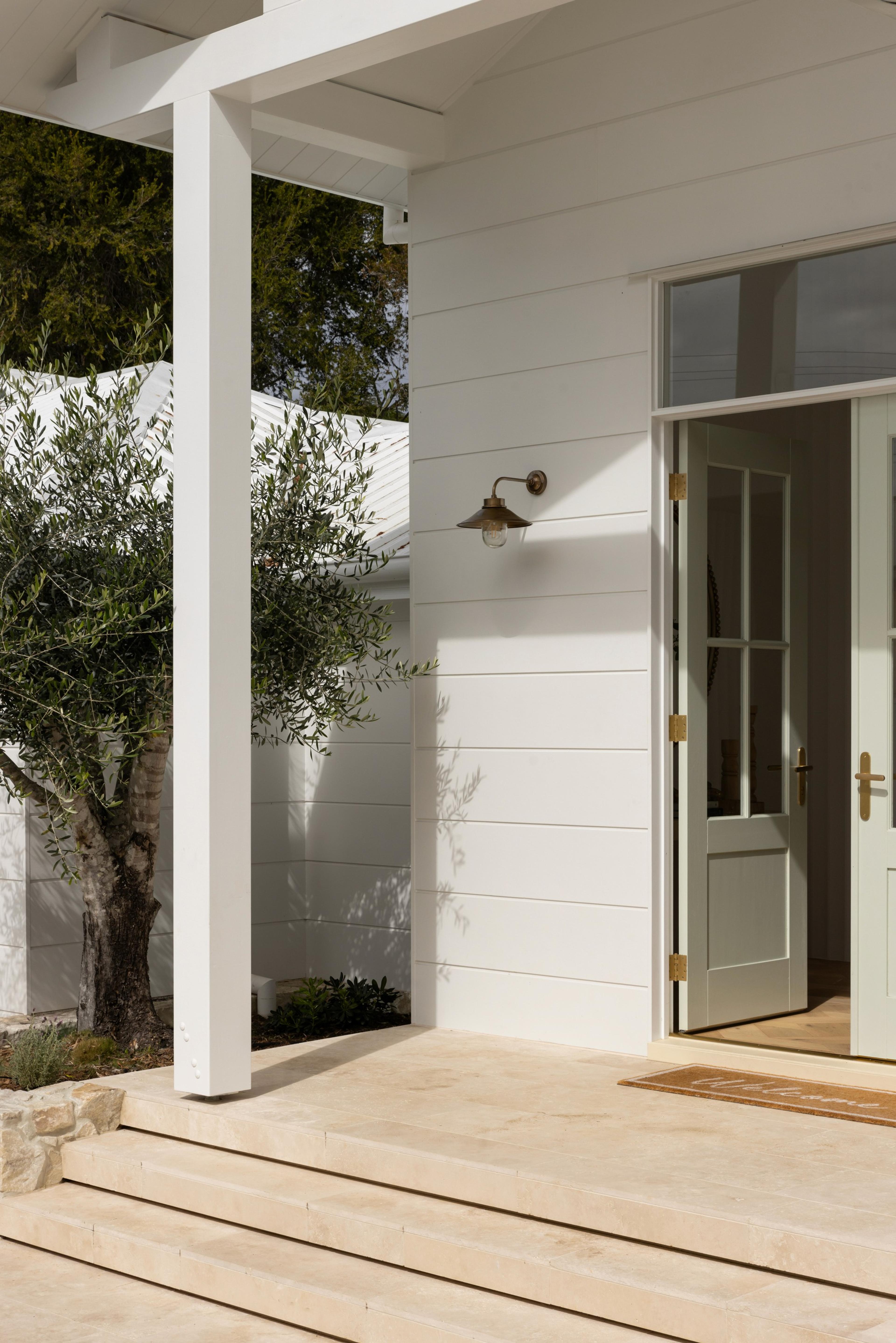 Front porch detail with glazed door and brass light