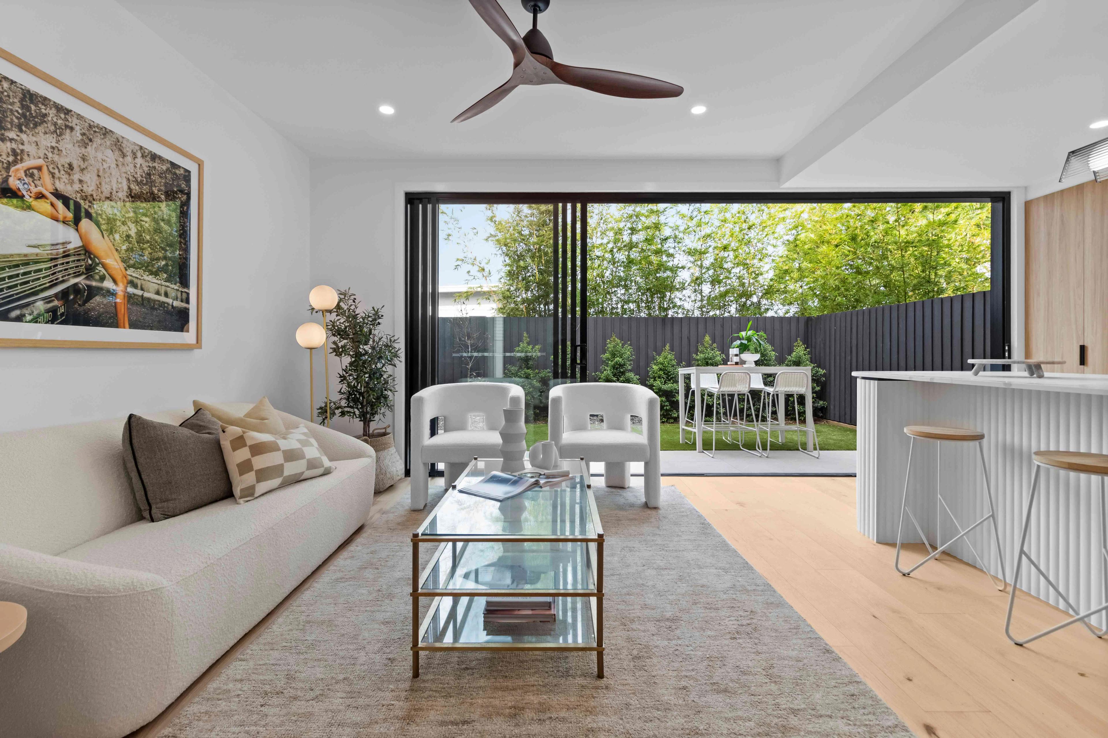 Open plan living room and kitchen with sliding doors to garden
