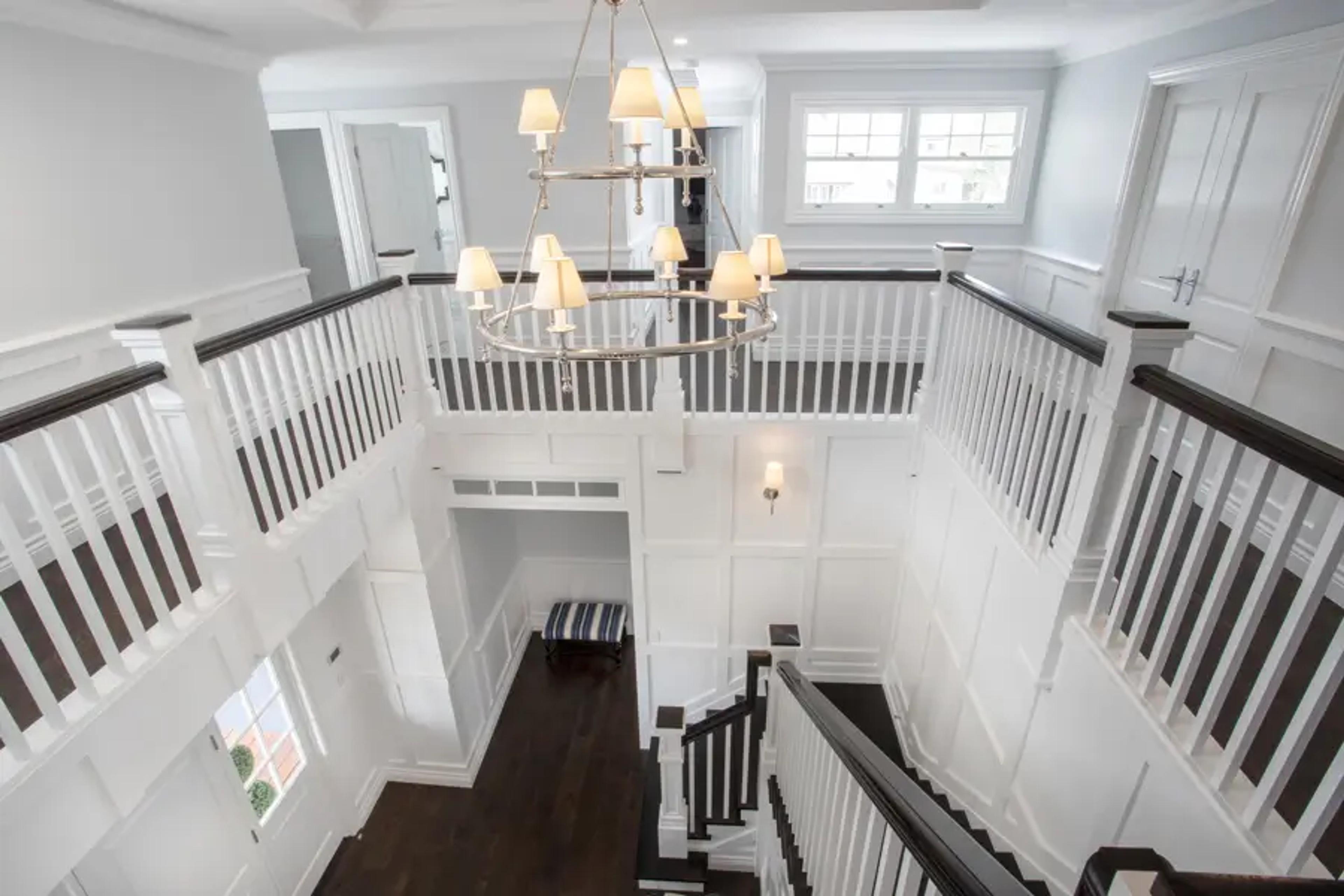Double height void and staircase with panelled walls