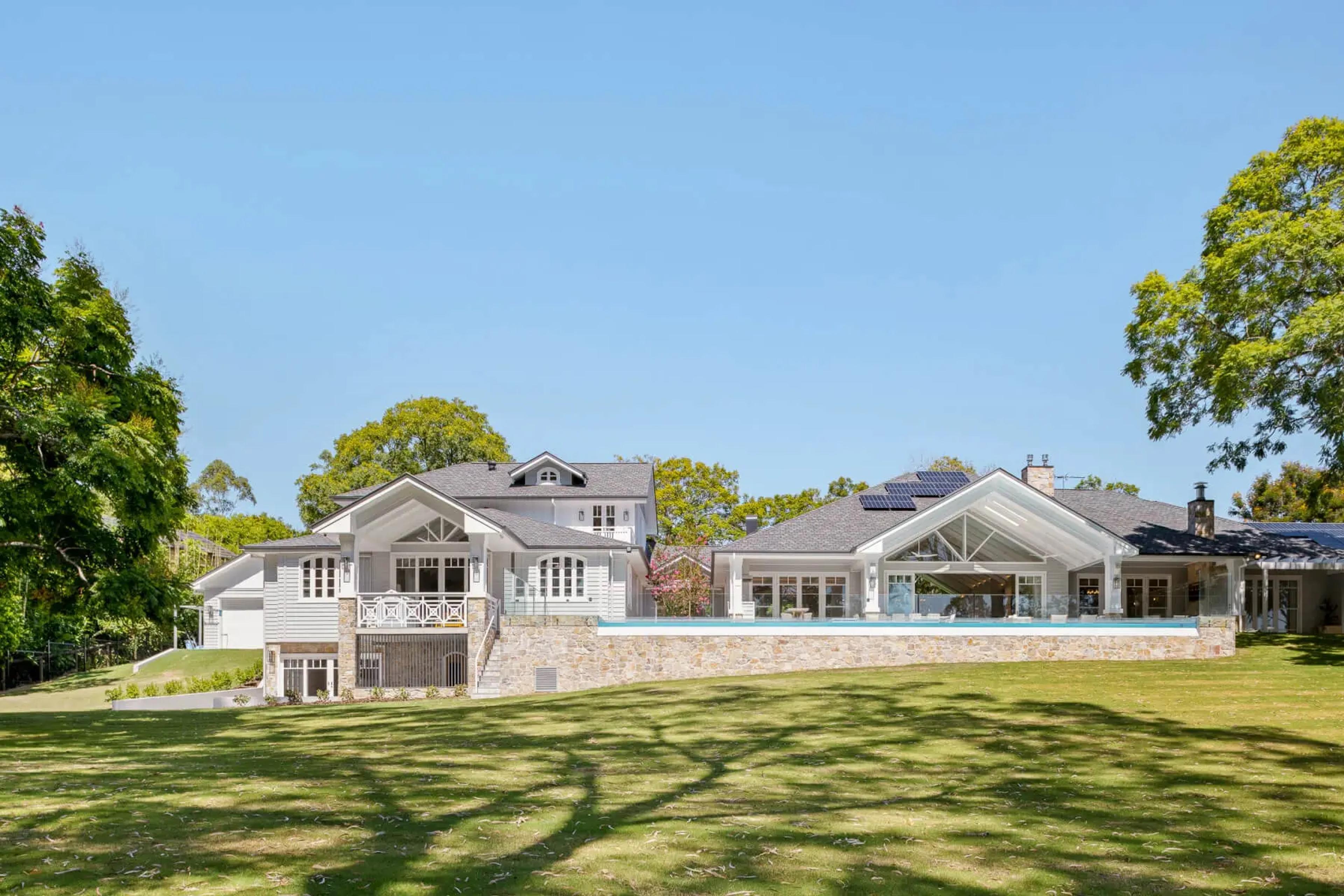 Rear elevation of Jacaranda House with pool and lawn