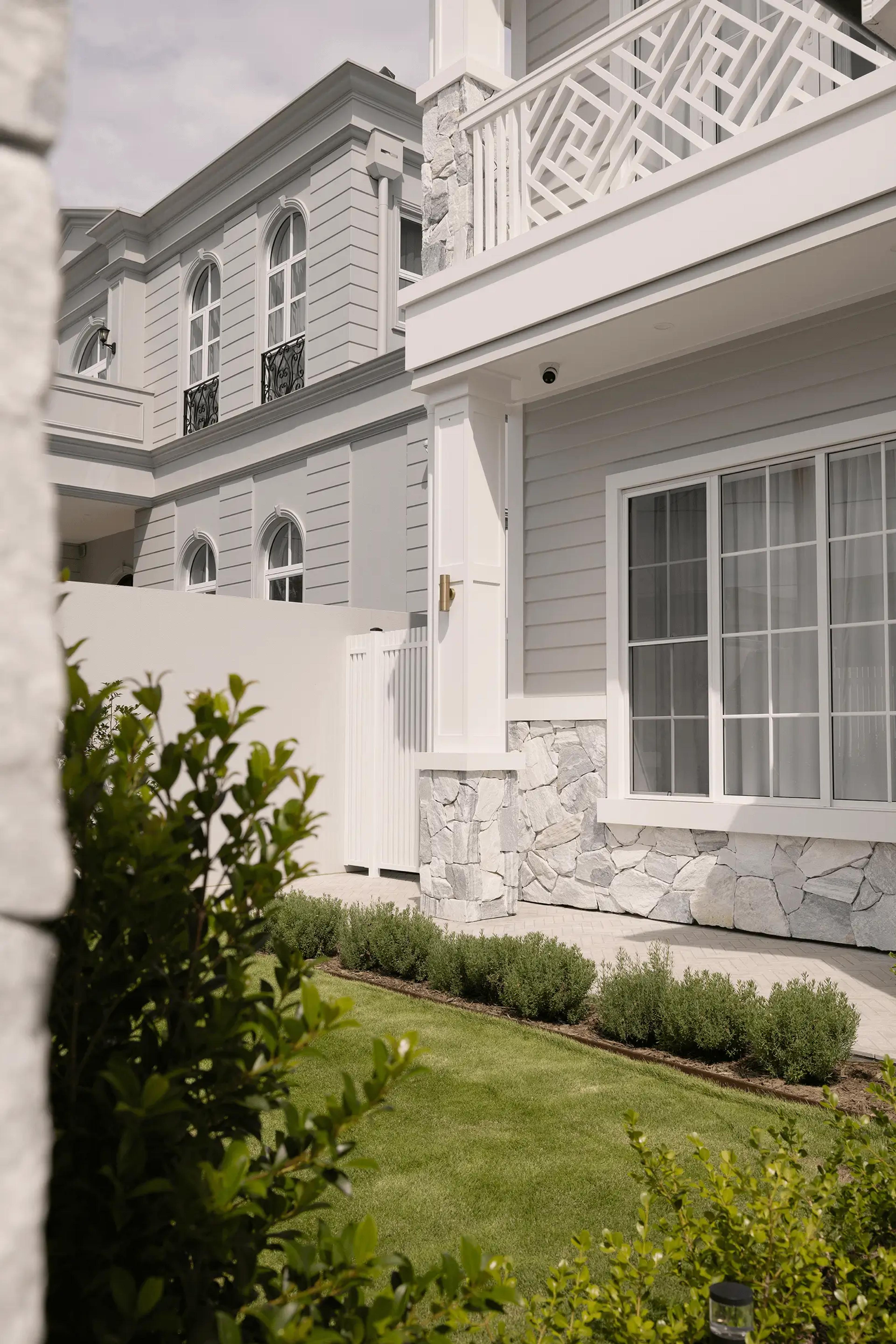Side exterior with weatherboard cladding and arched windows