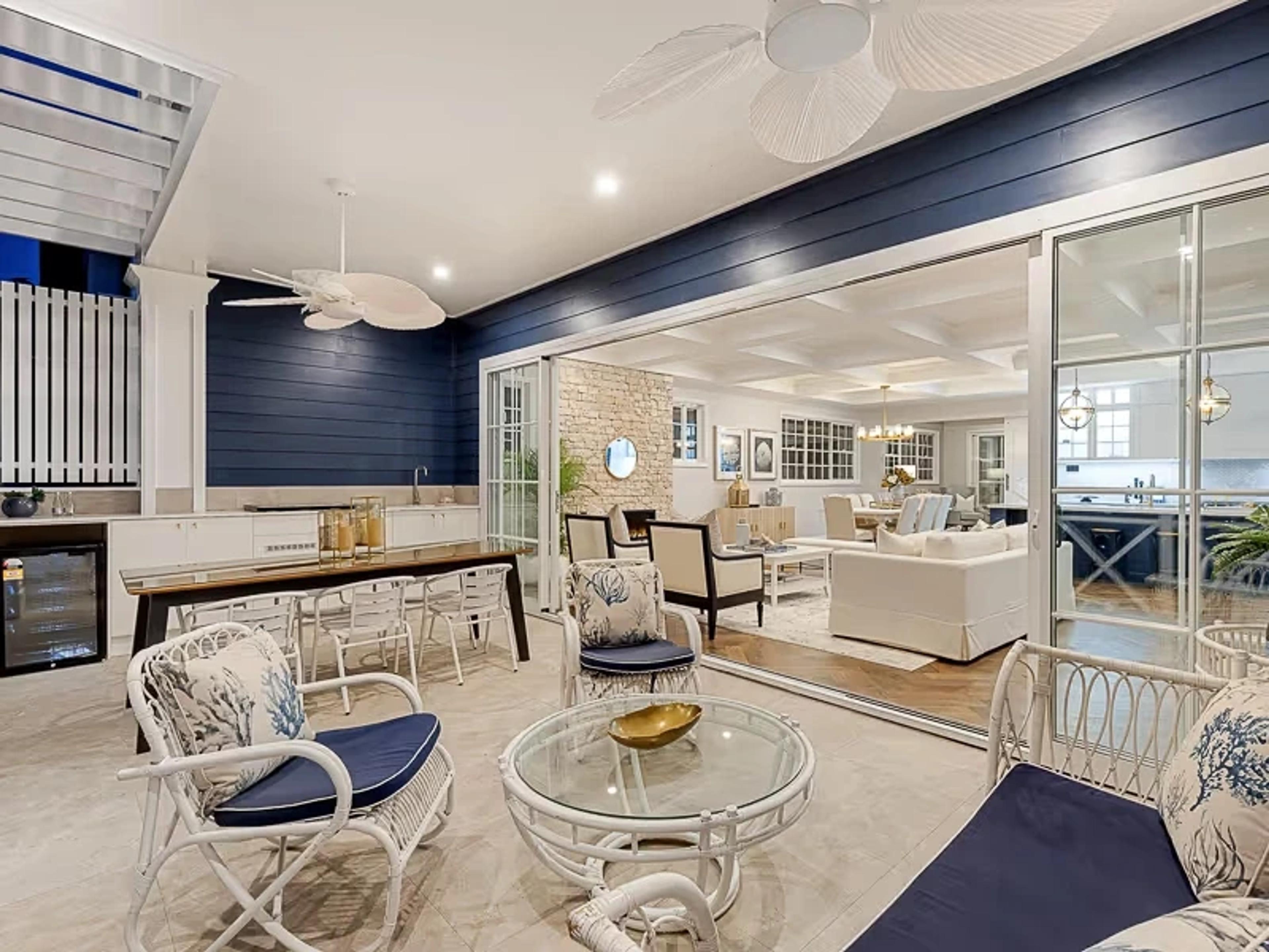 Outdoor entertaining lounge with navy panelling and bar