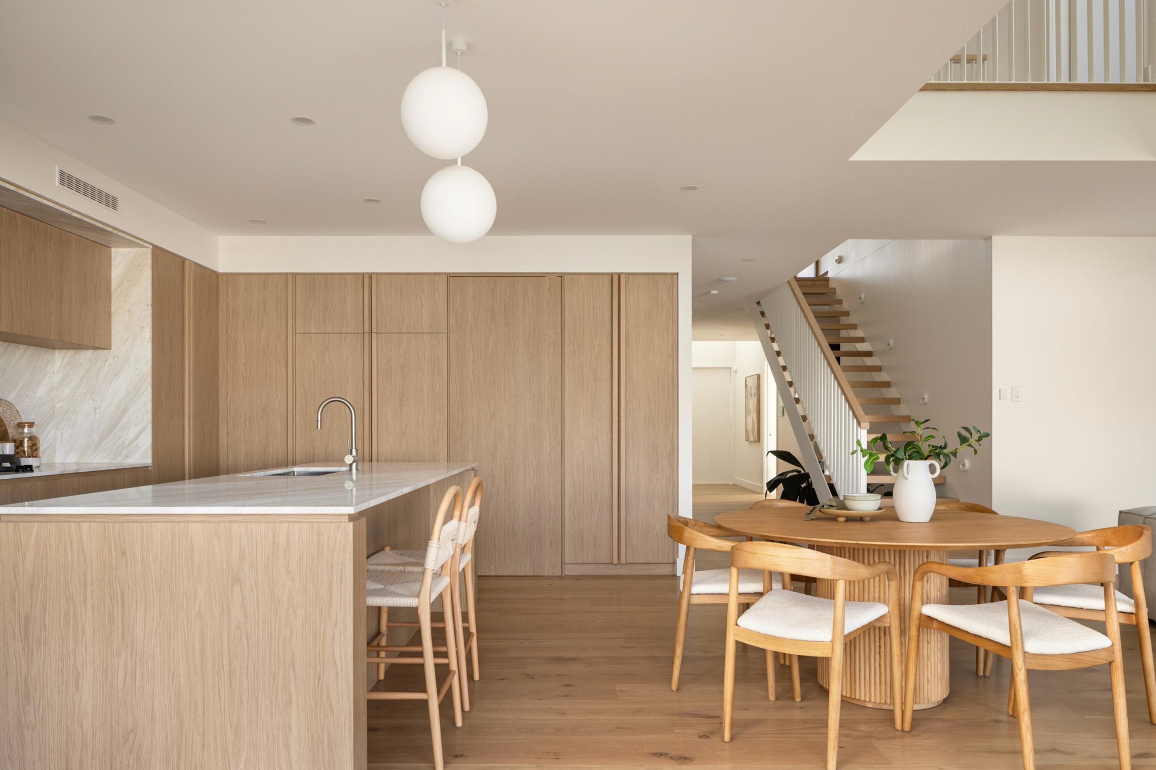 Kitchen and dining area beside timber staircase