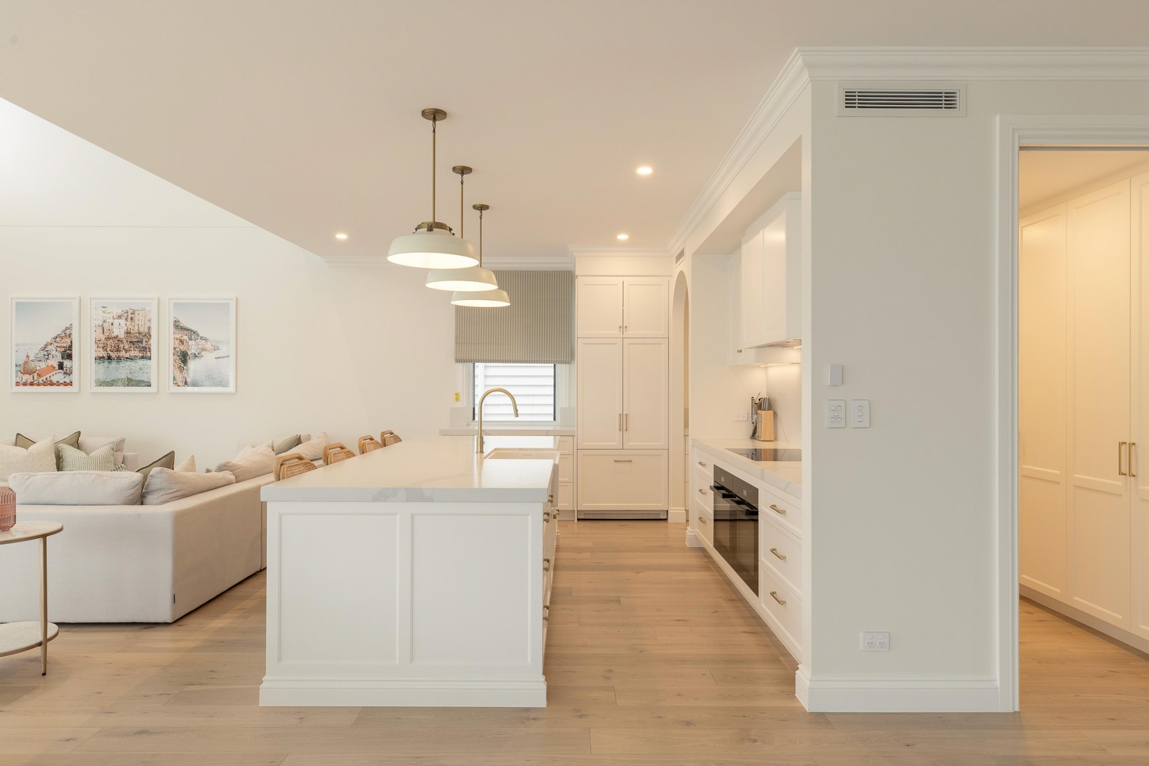 Open plan kitchen island, oven and adjoining living area