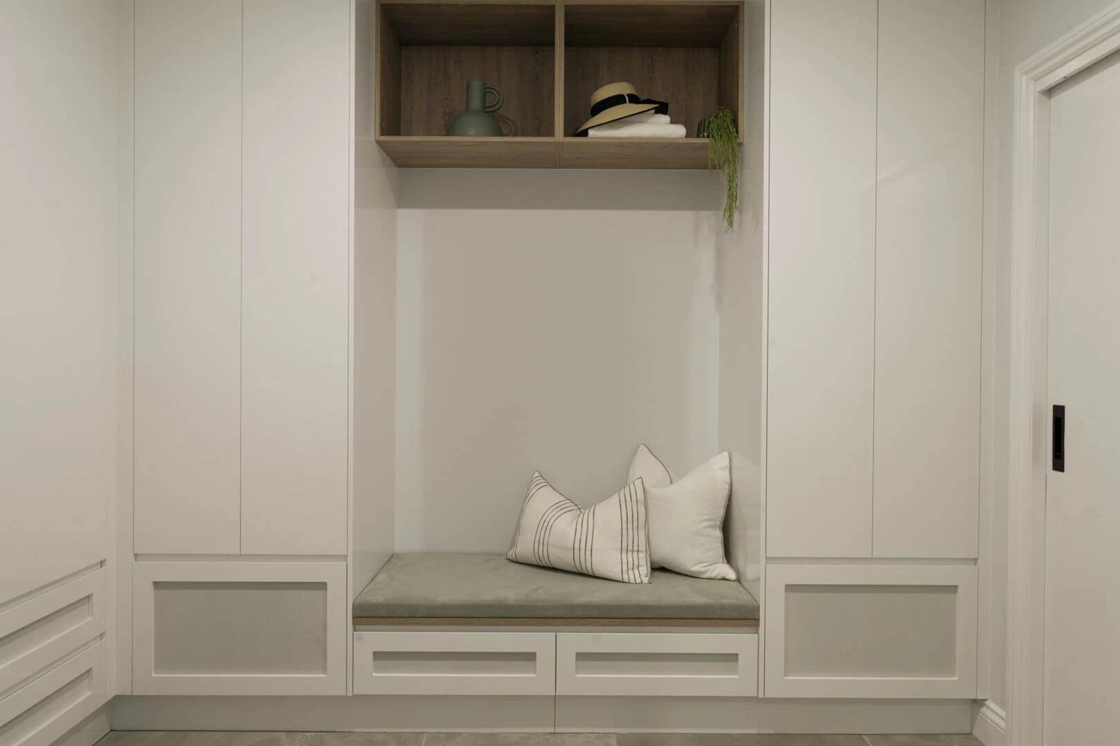 Mudroom bench seat with cushions and timber overhead cabinet
