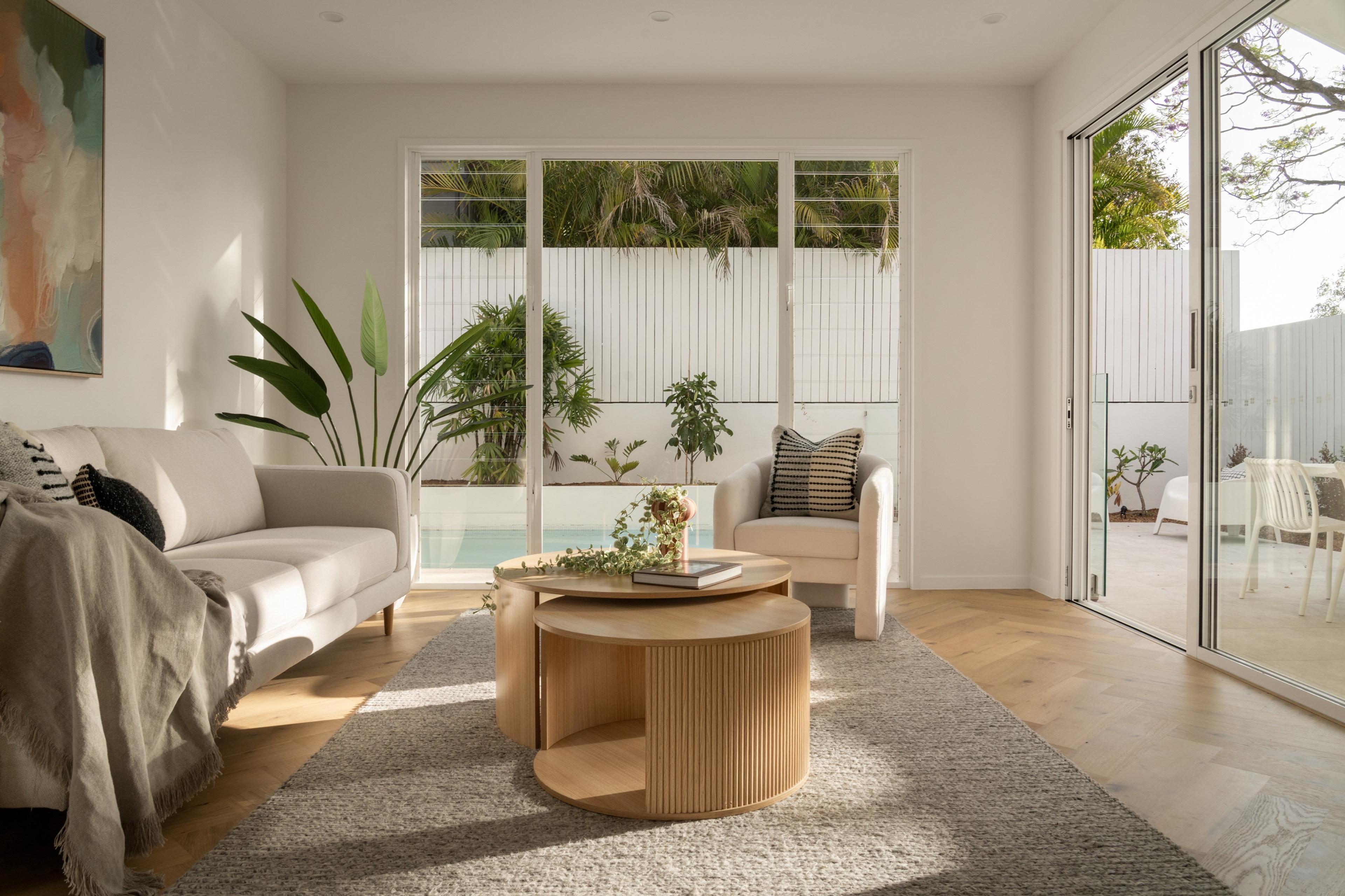 Sitting room opening to poolside courtyard through sliding doors