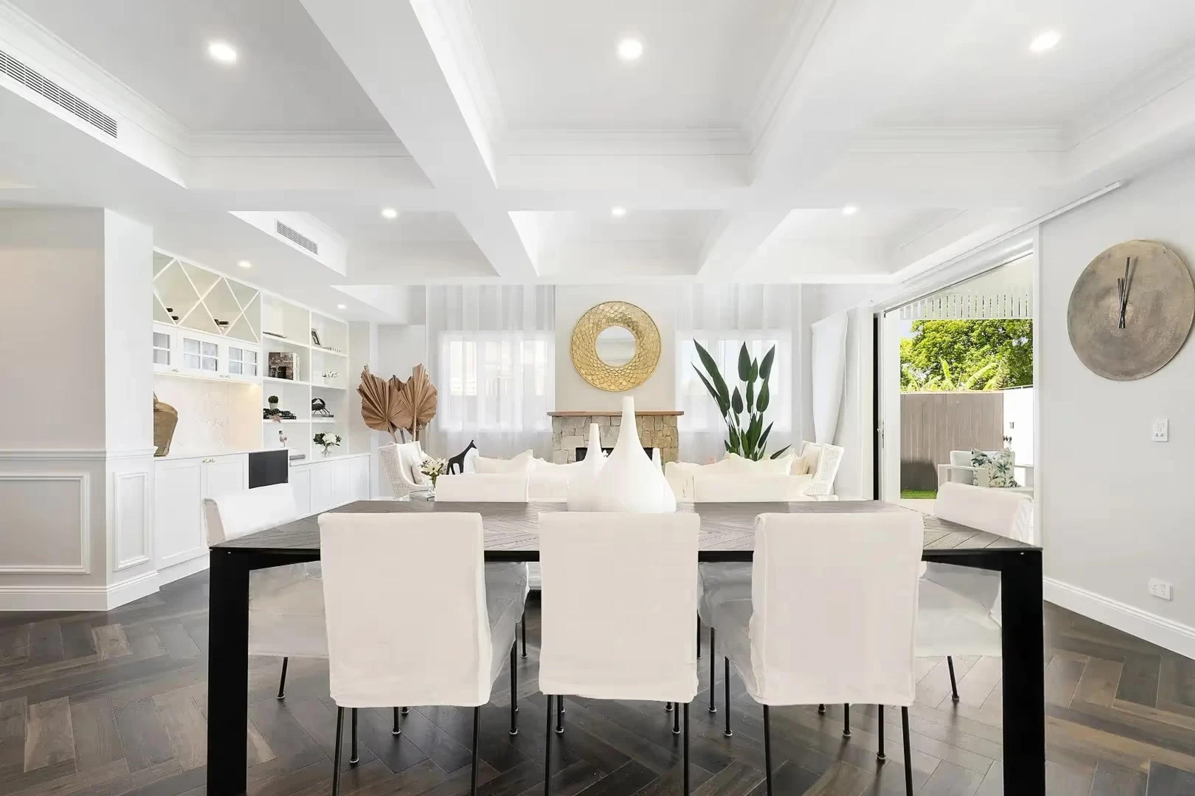 Formal dining area with coffered ceiling and black timber table
