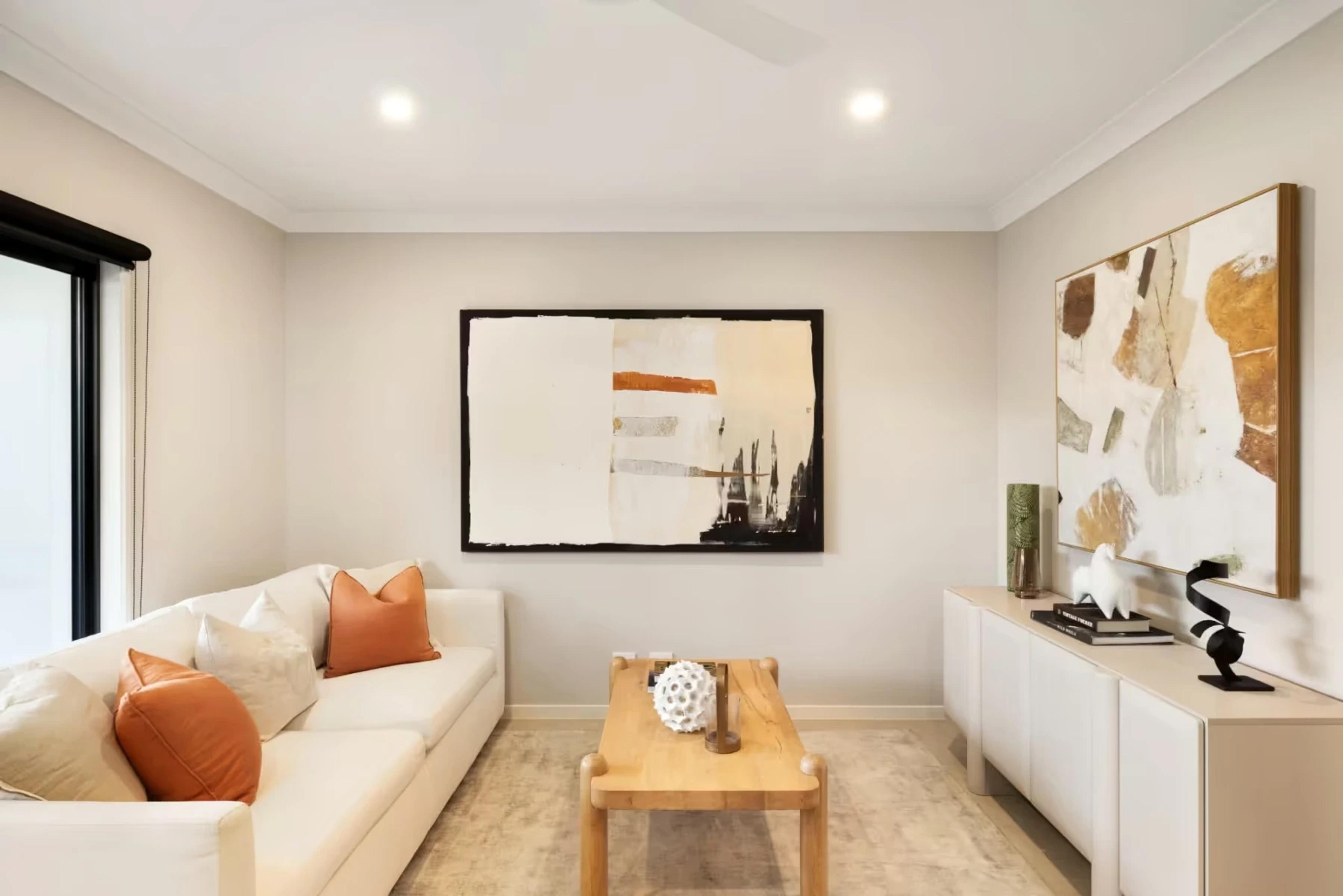 Living room with cream sofa and framed artworks
