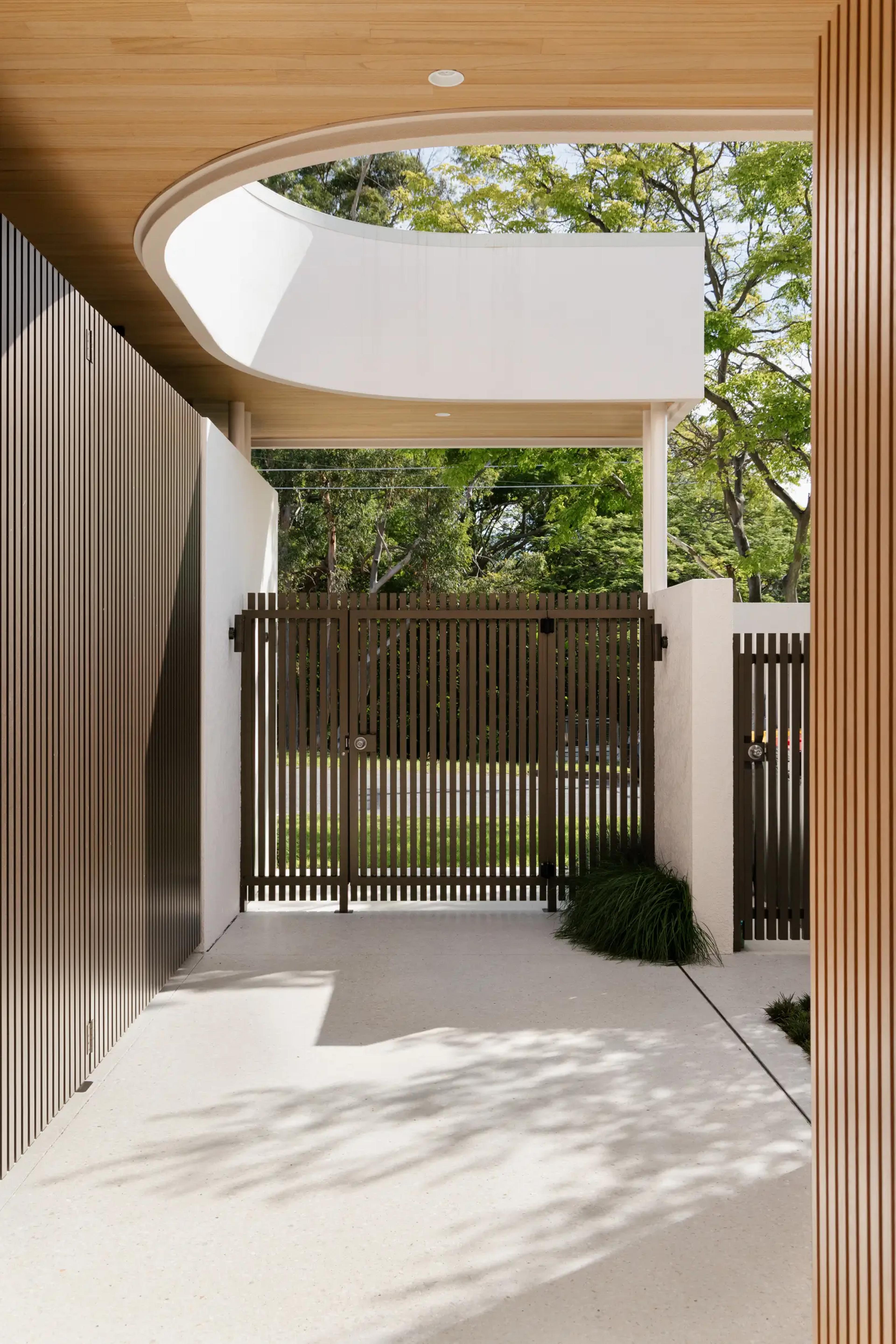Entry passage looking out to timber gate and street