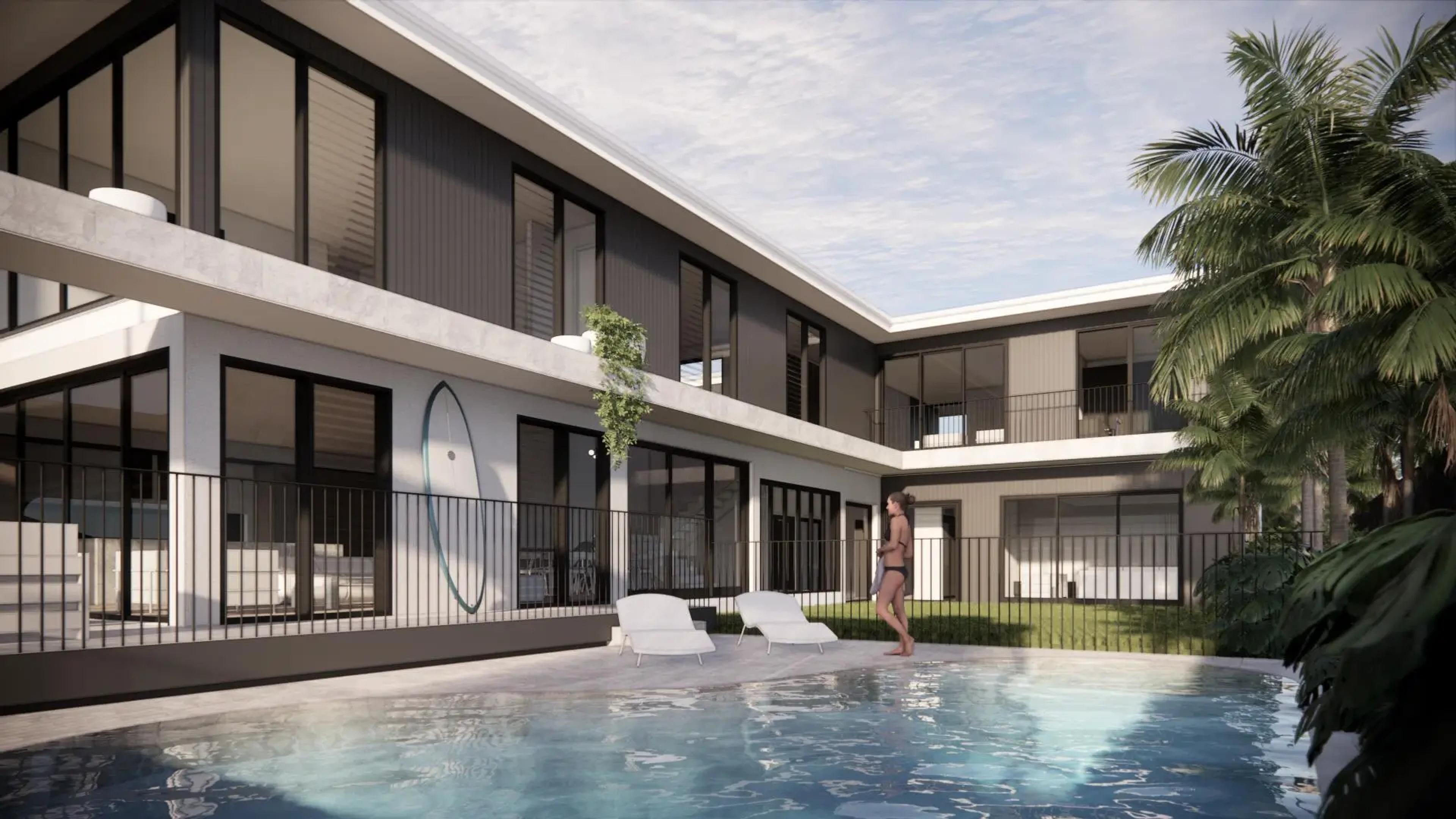 Pool courtyard framed by black and white two storey home