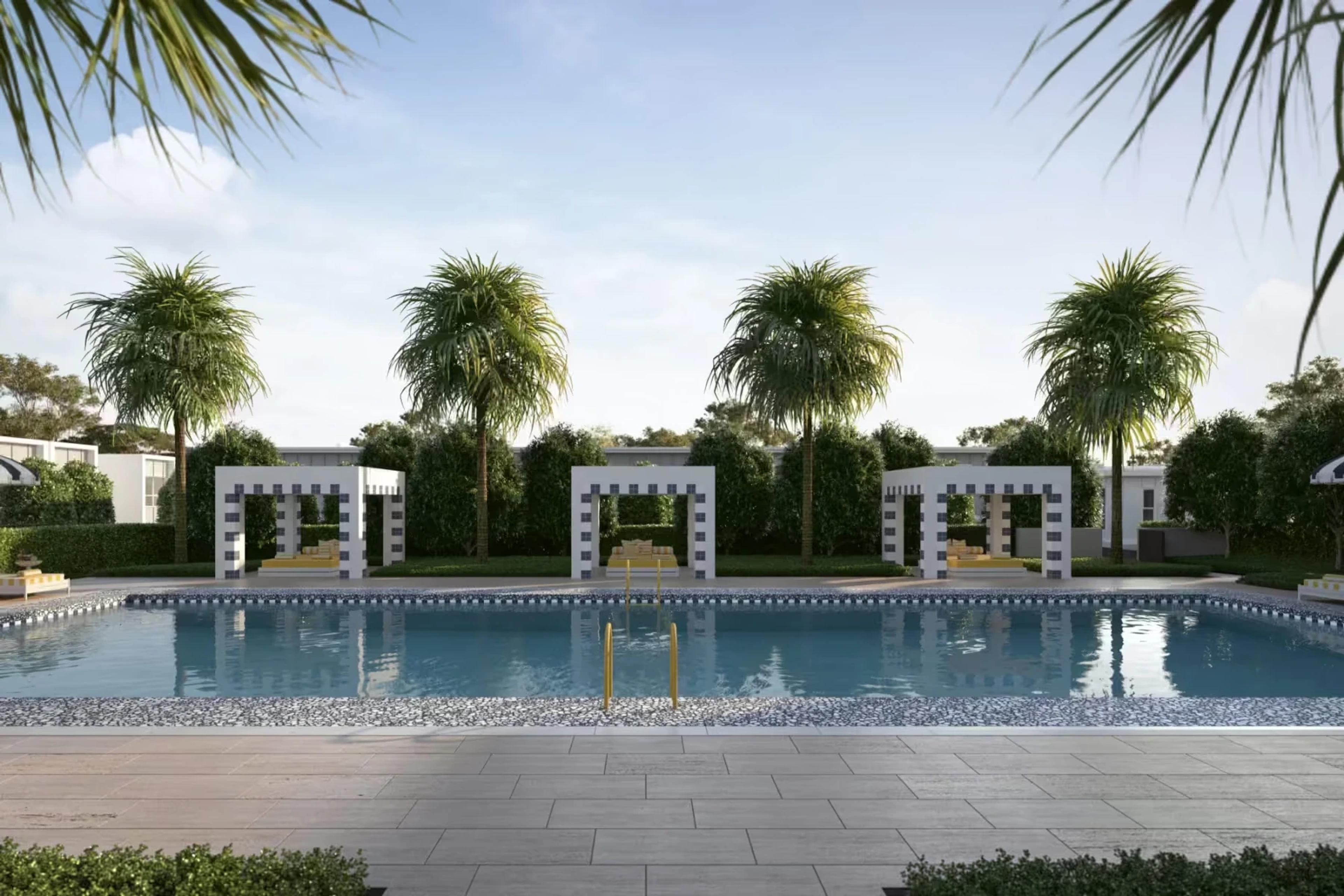 Communal swimming pool with pavilions and palm trees