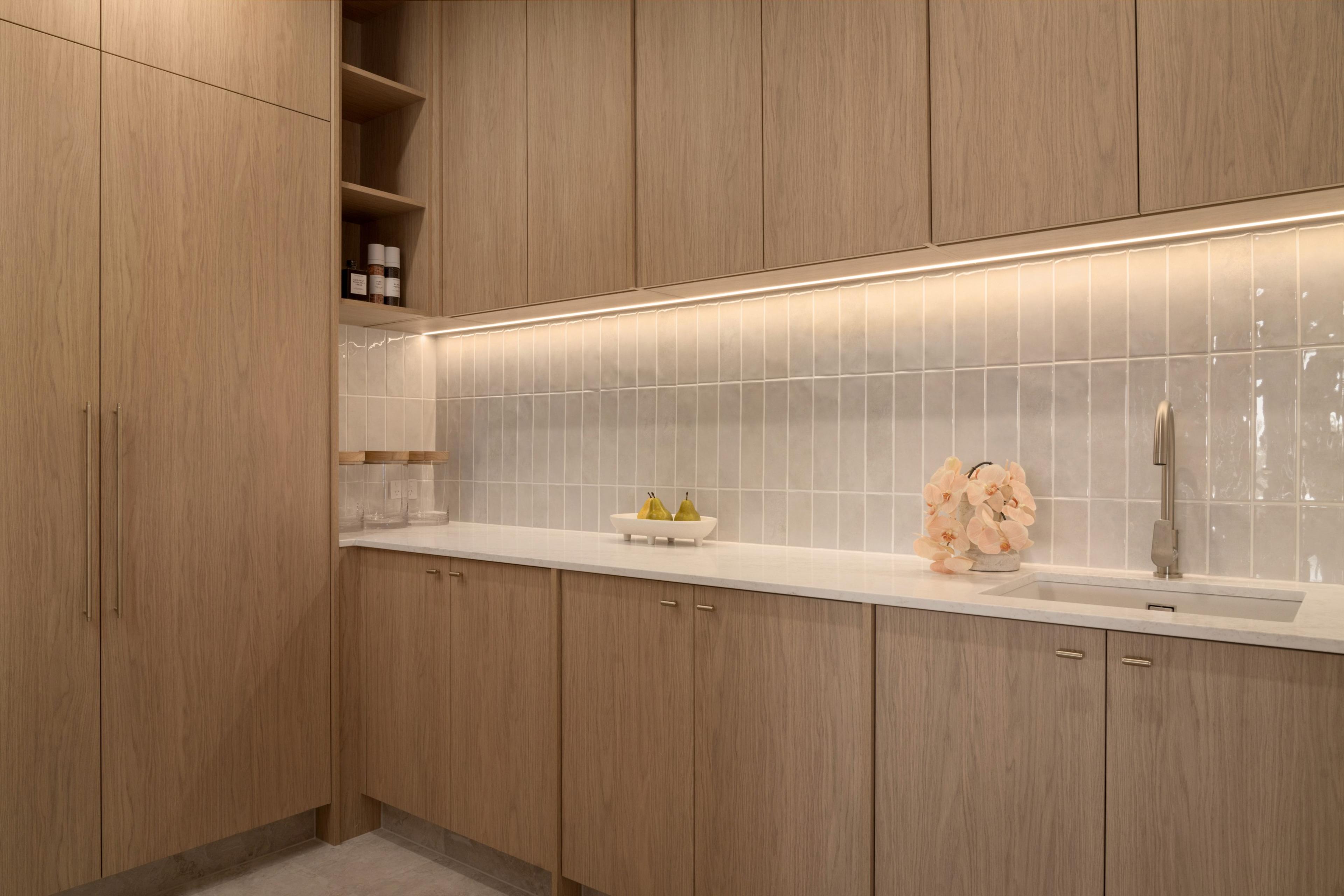 Butler pantry with timber joinery and tiled splashback