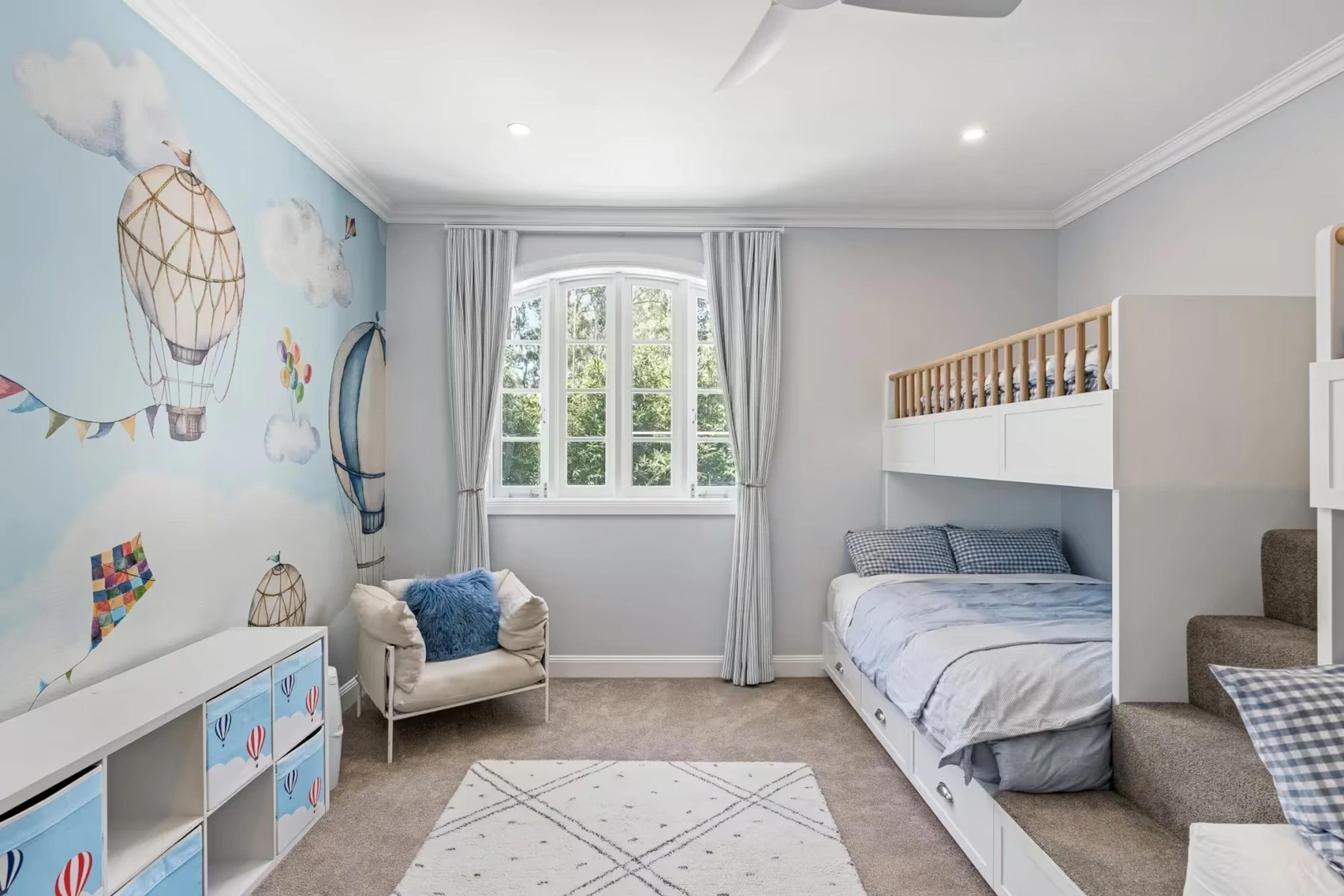 Childrens bedroom with hot air balloon mural and bunk beds