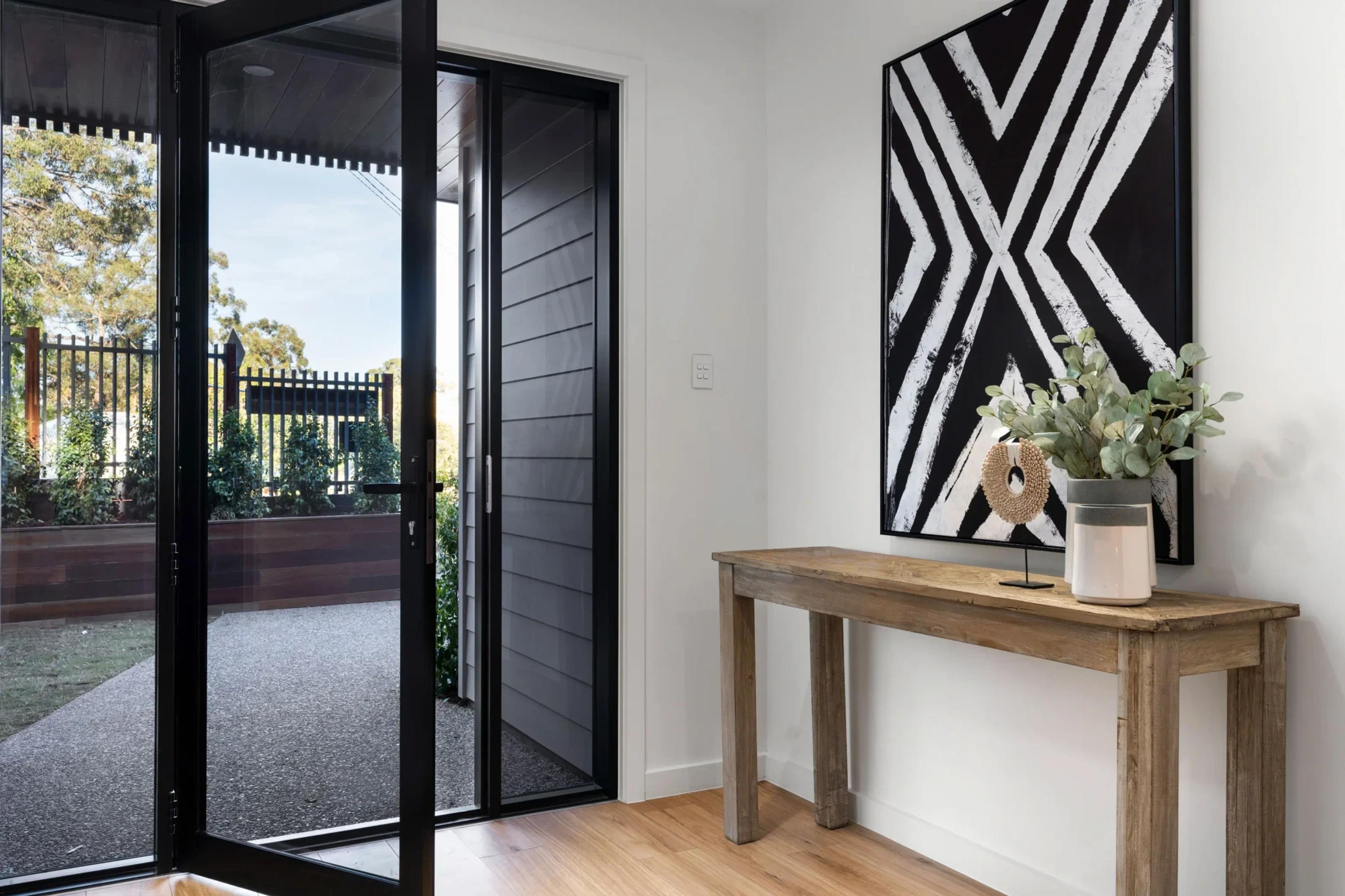 Entry foyer with glass door and timber console table