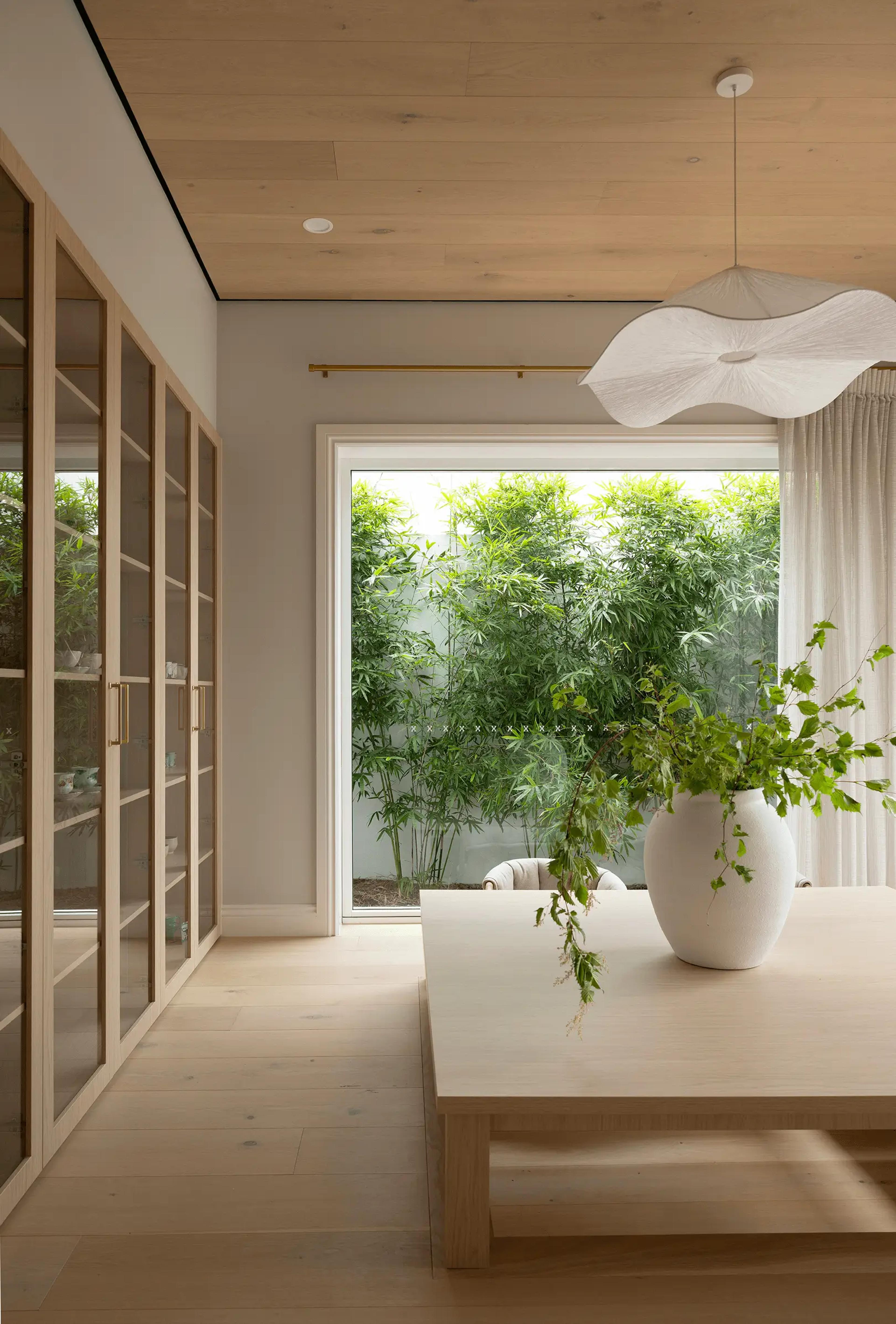 Tea room with timber ceiling and bamboo courtyard outlook