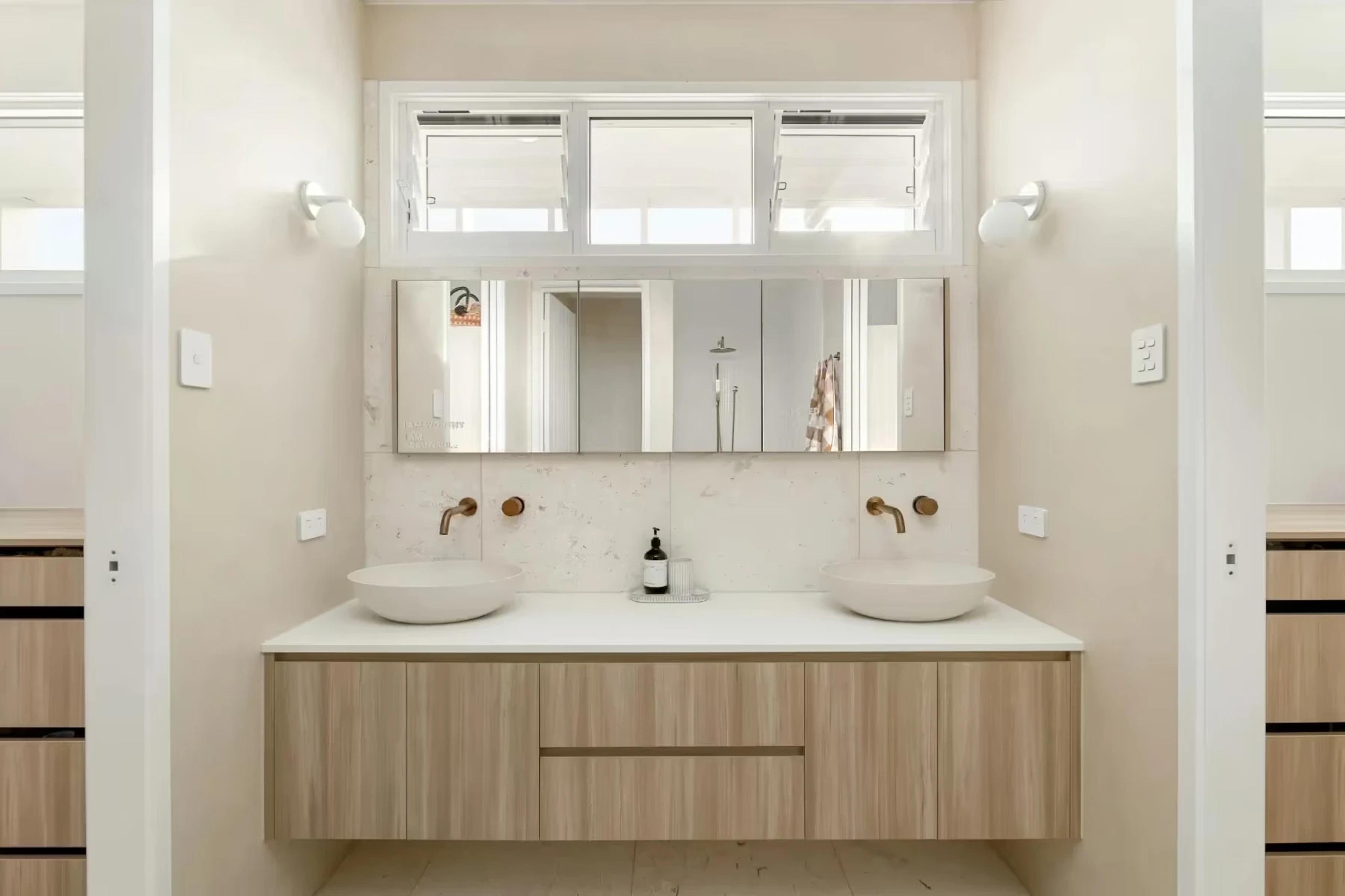 Bathroom with twin basins, timber vanity and louvre windows