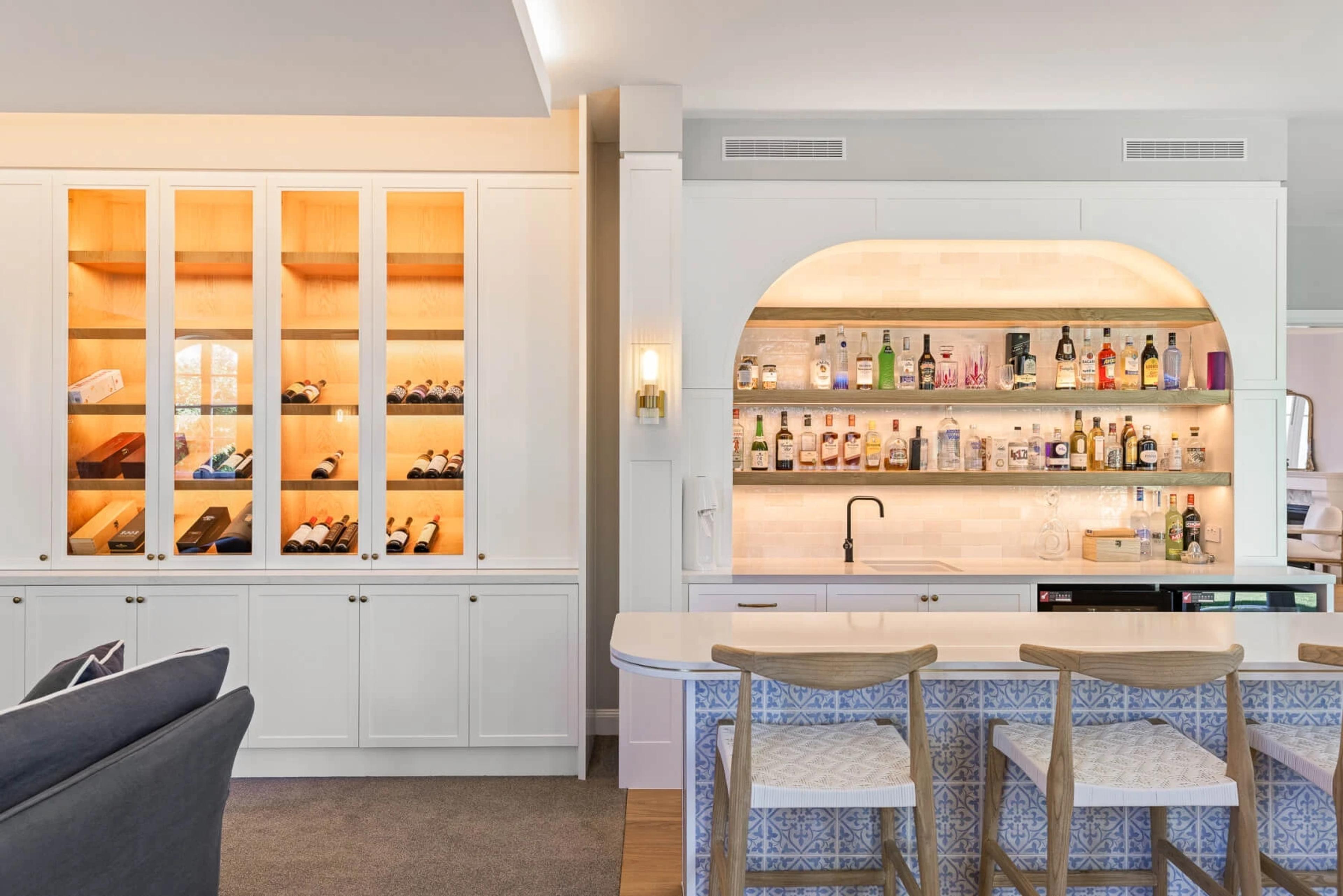 Home bar with backlit shelving and tiled island