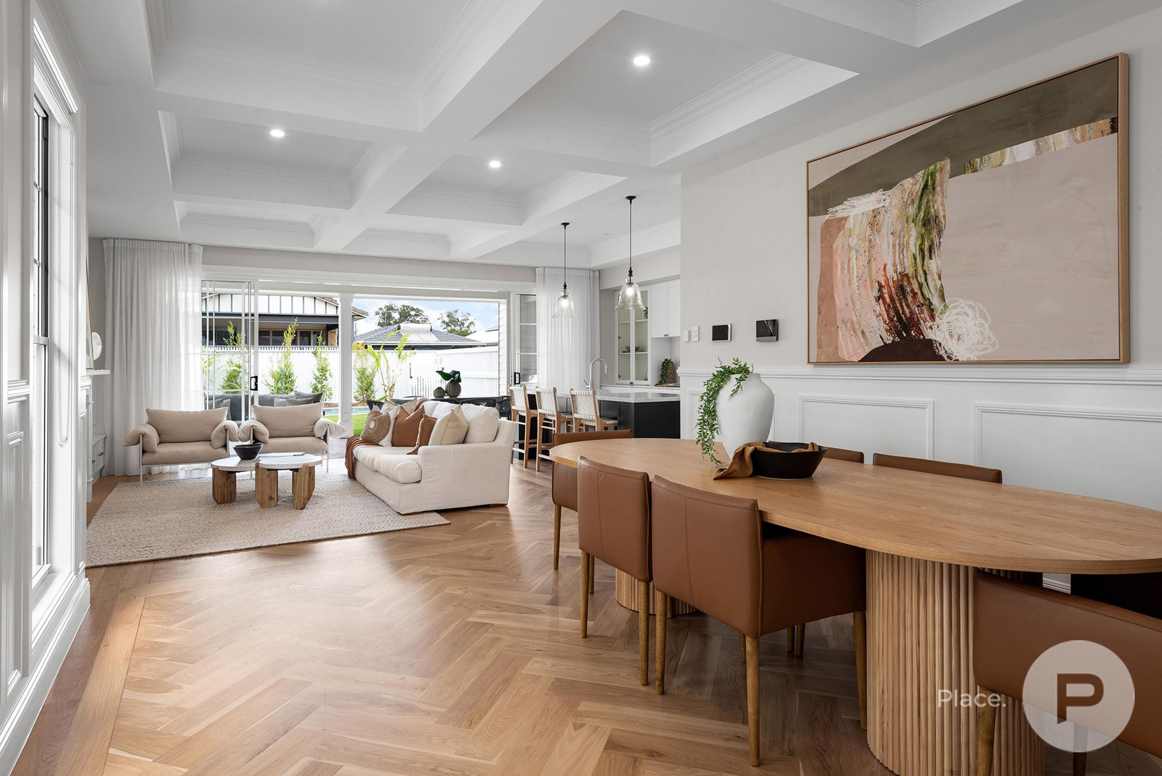 Open plan dining and living area with herringbone floor