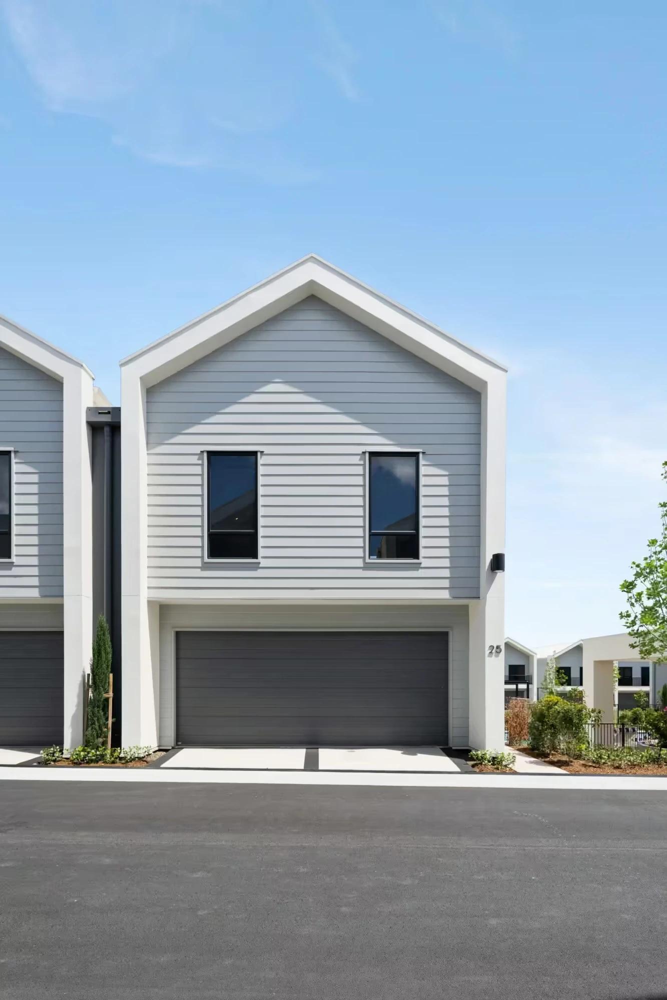 Front elevation of a two storey gabled townhouse with garage