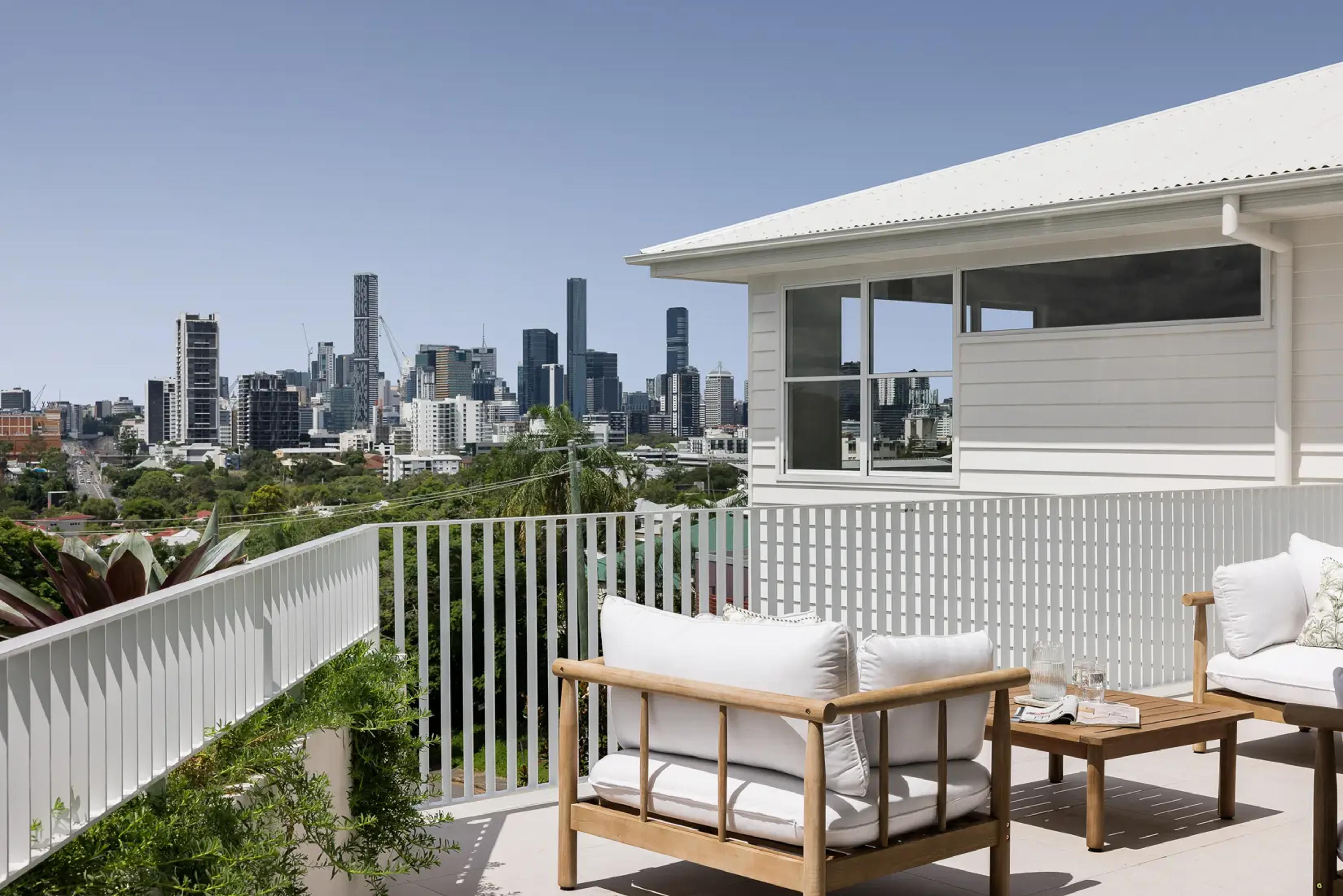 Balcony seating with sweeping city skyline view beyond