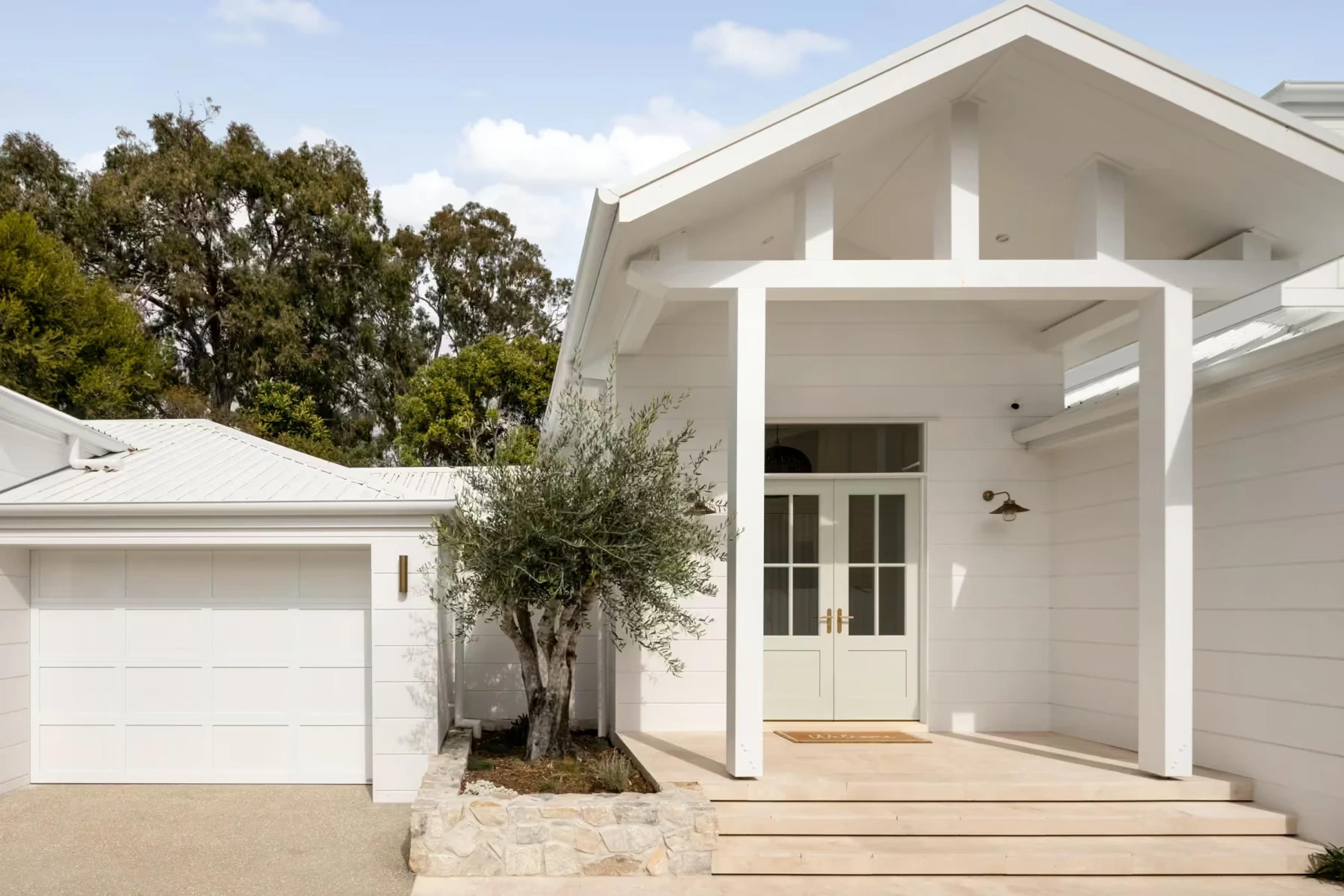 Coastal home facade showing light-toned cladding and architectural detail designed by Invilla Architecture.