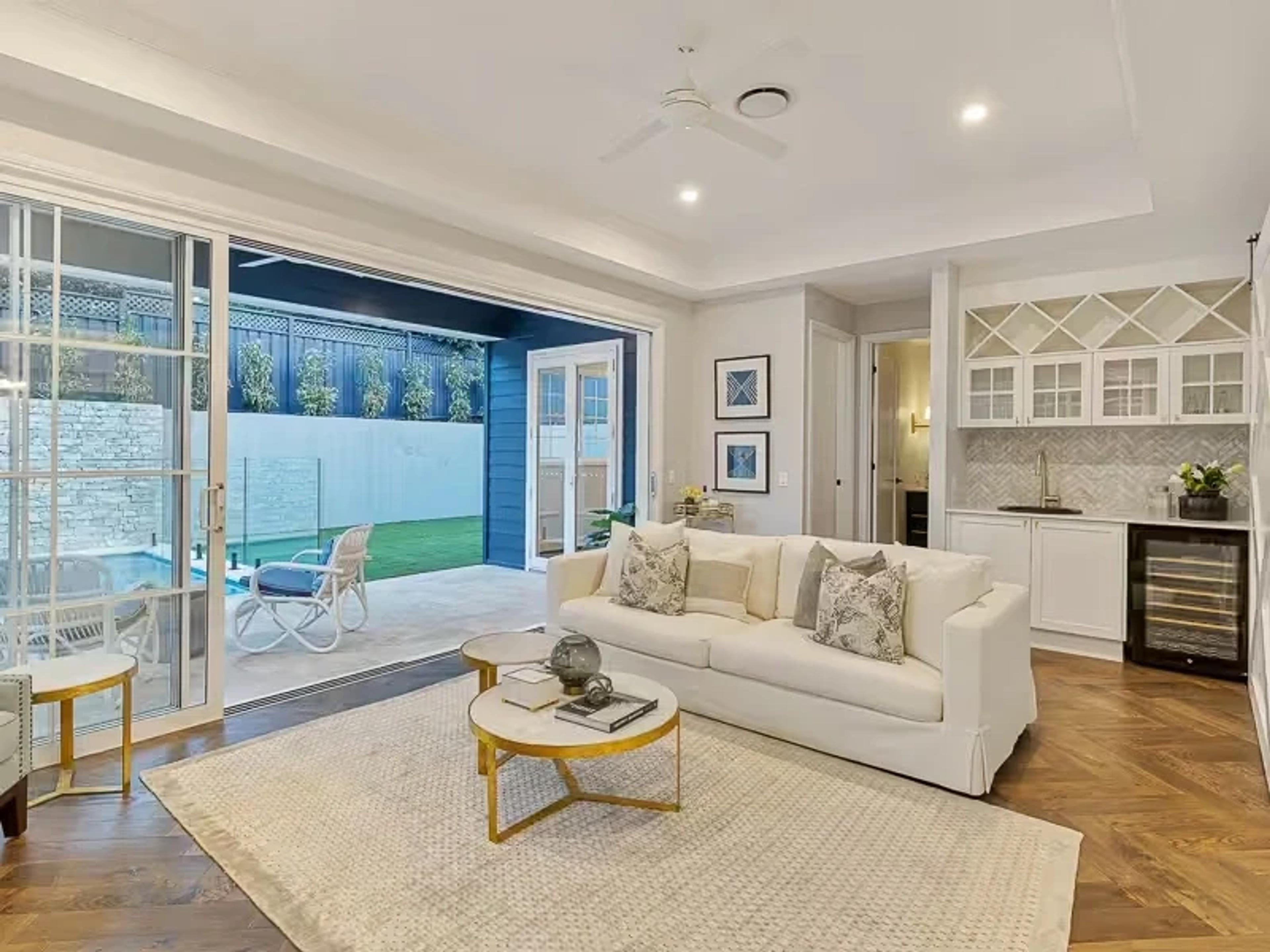 Living area opening to pool and courtyard with bar cabinetry