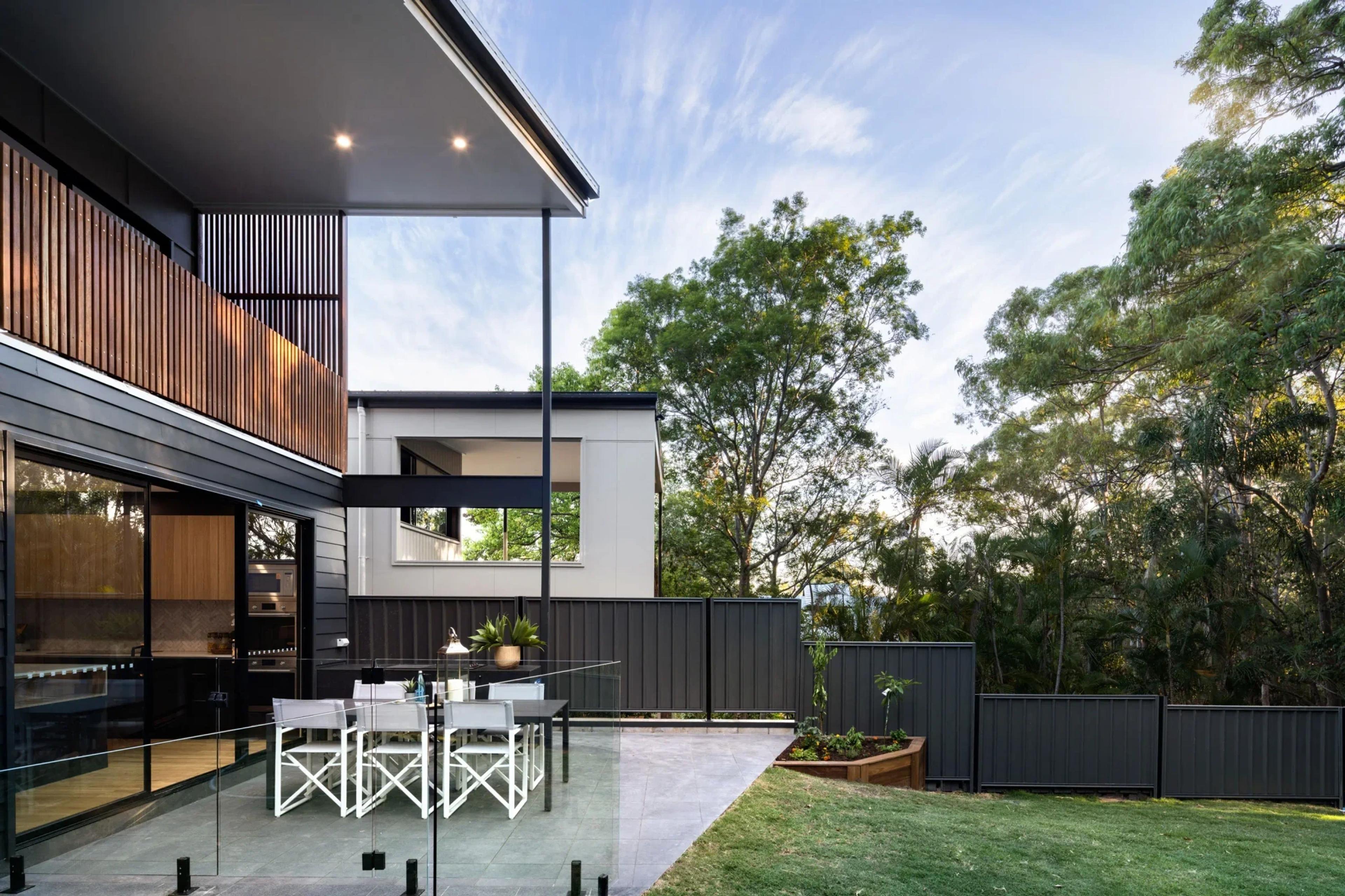 Rear exterior with alfresco terrace, timber cladding and garden