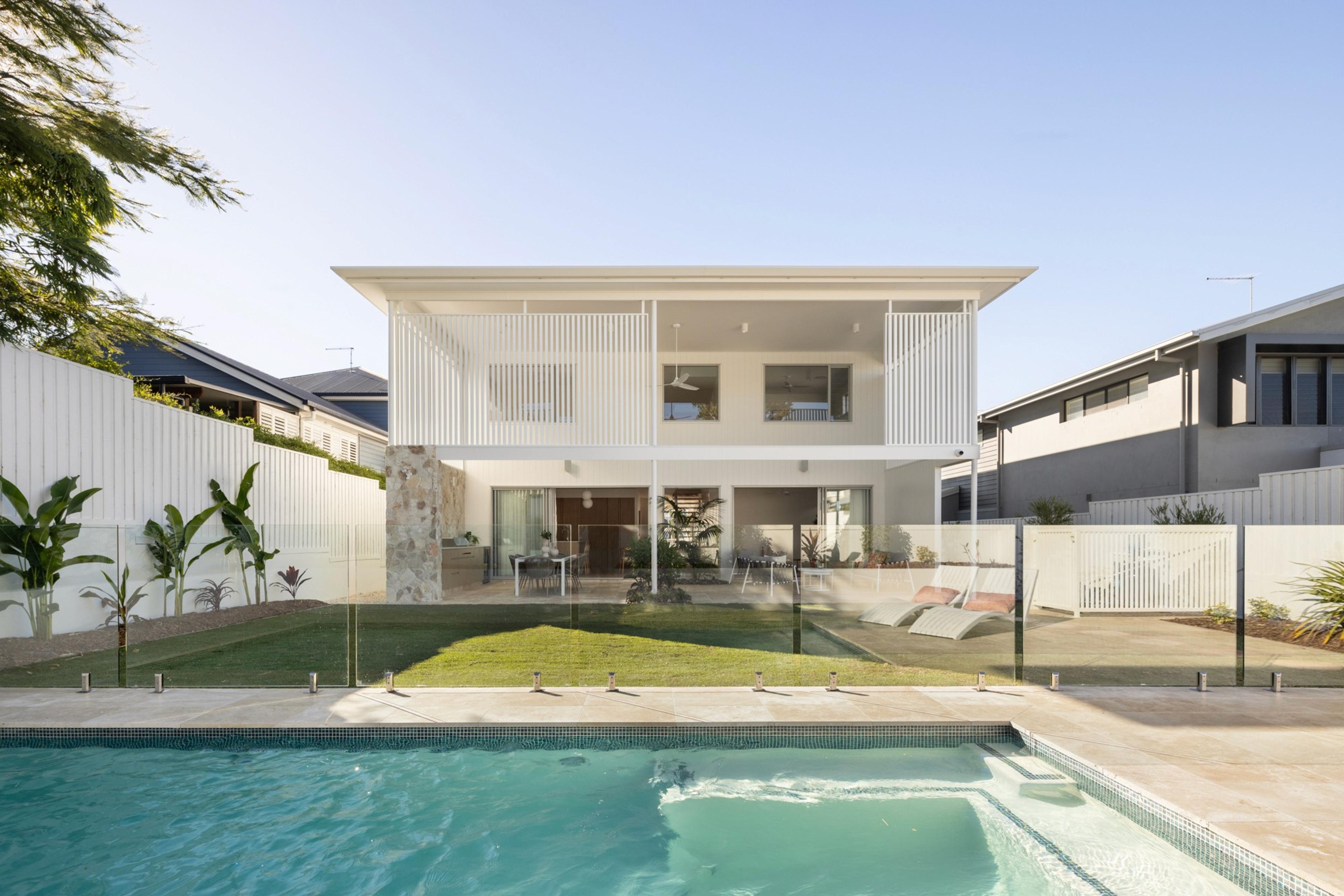 Rear elevation of home overlooking backyard swimming pool