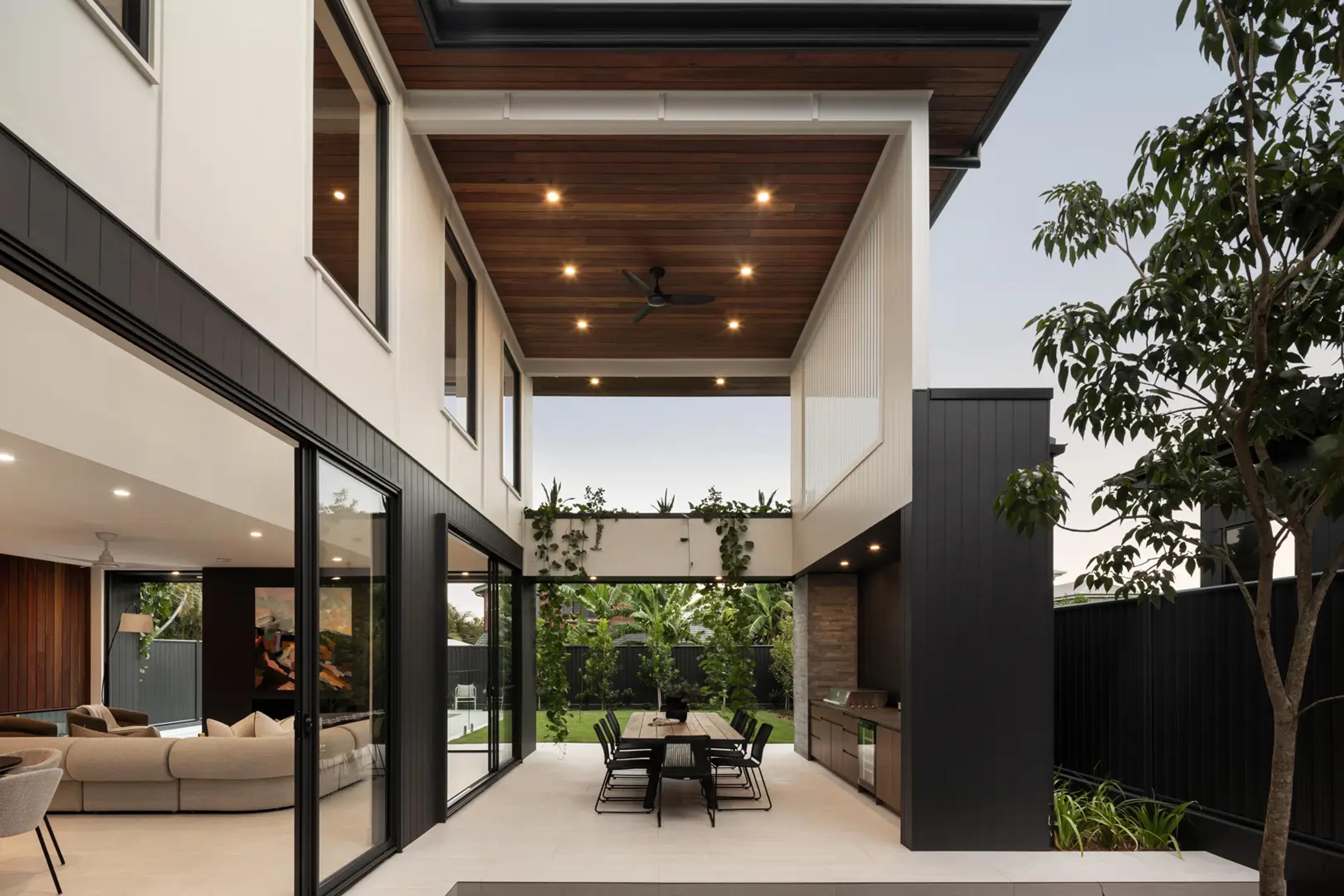 Open plan dining and living with timber ceiling