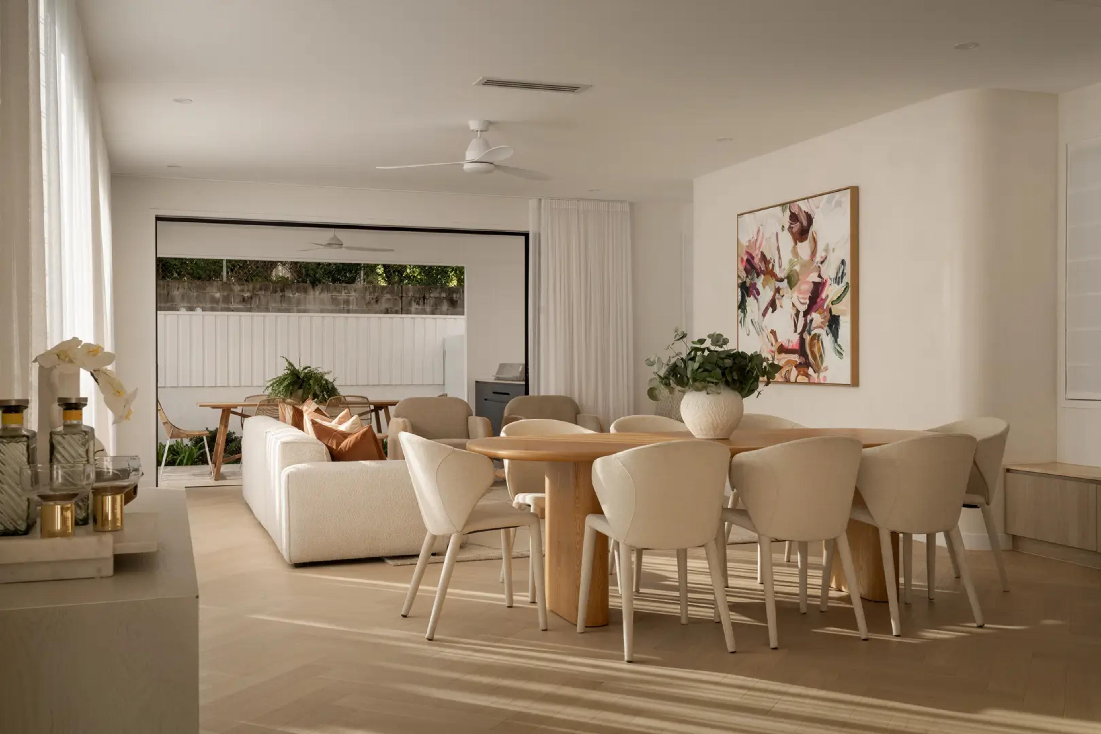 Open dining area with timber table and framed artwork