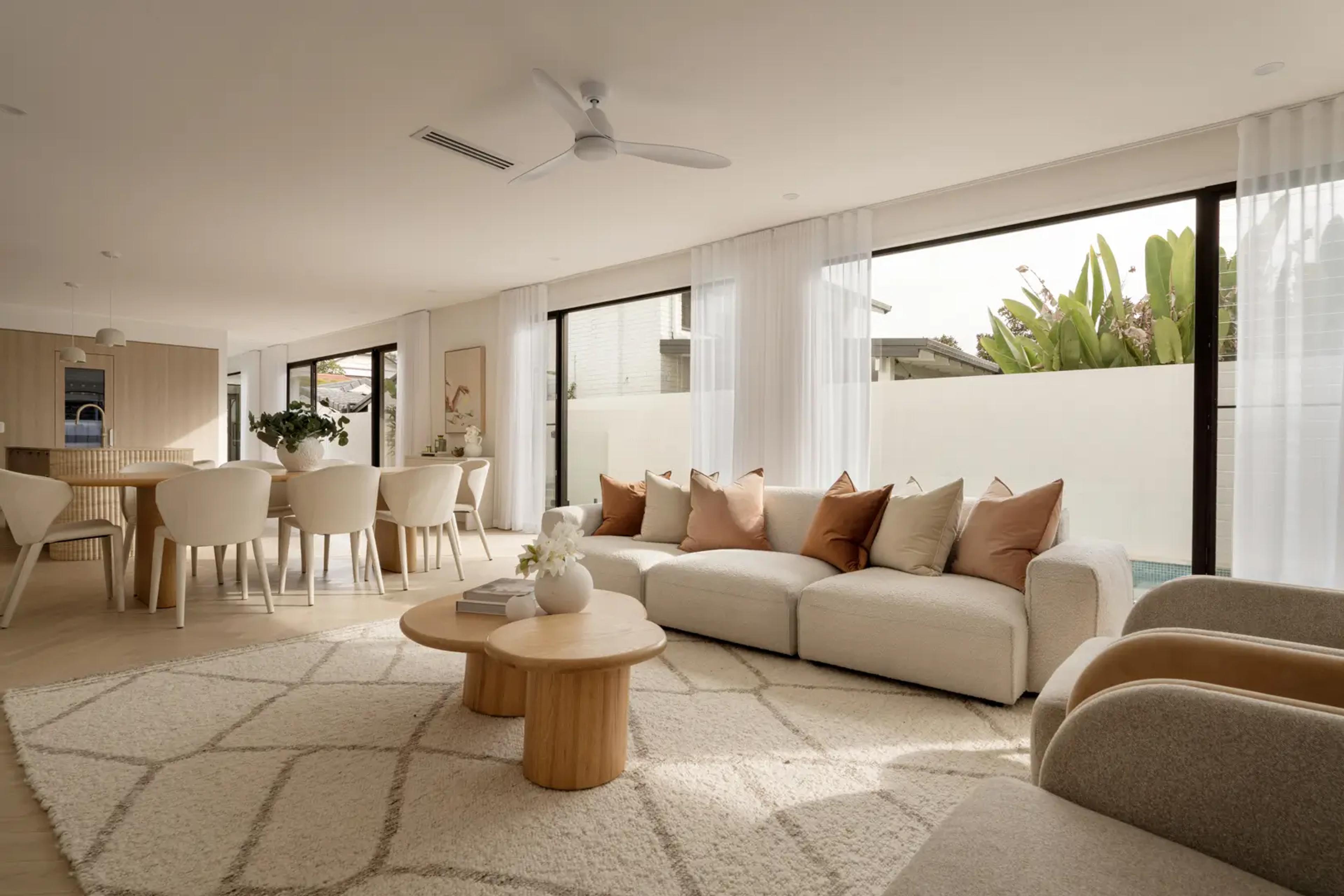 Living and dining area opening to courtyard through glass doors