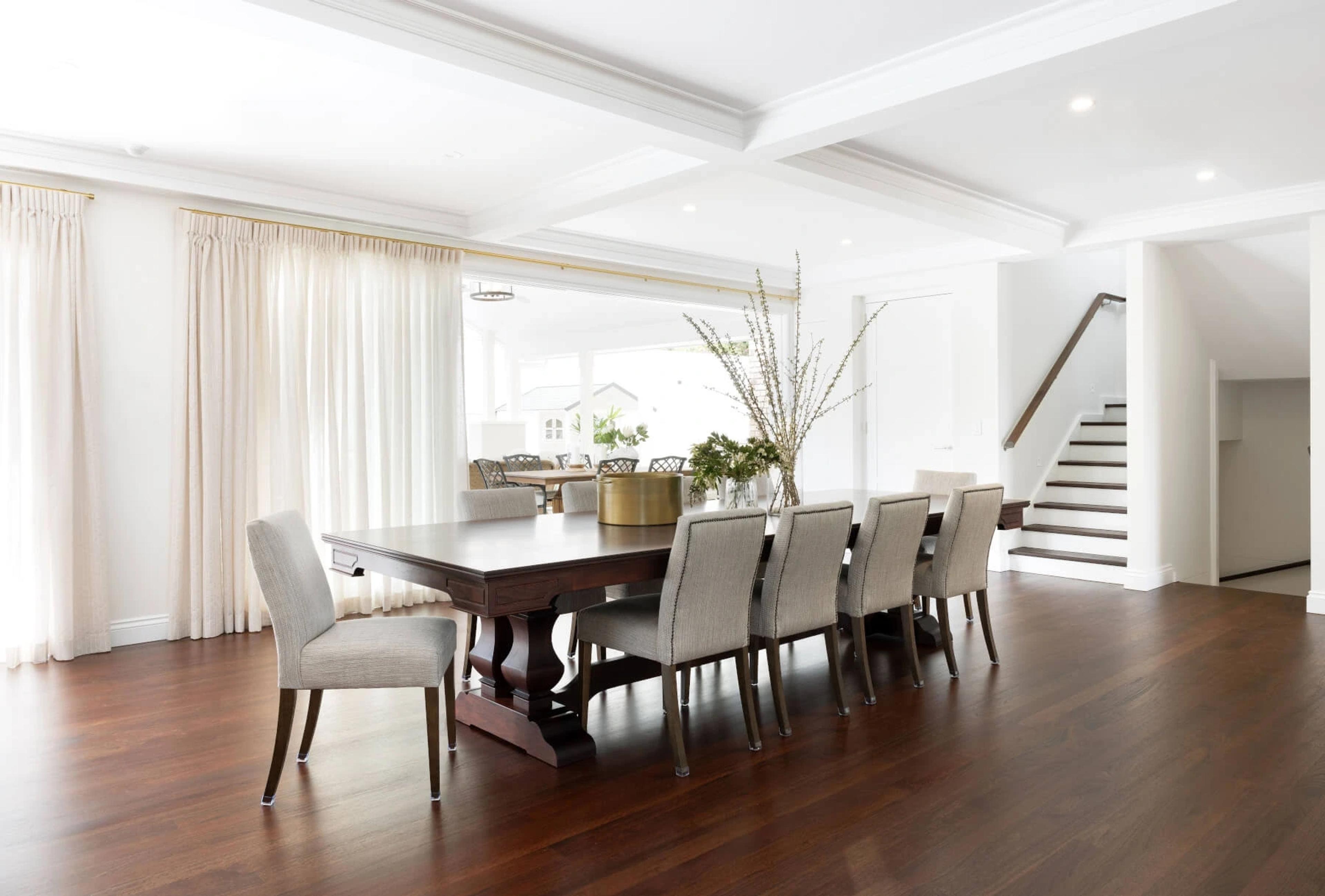 Formal dining room with dark timber floors and stairs