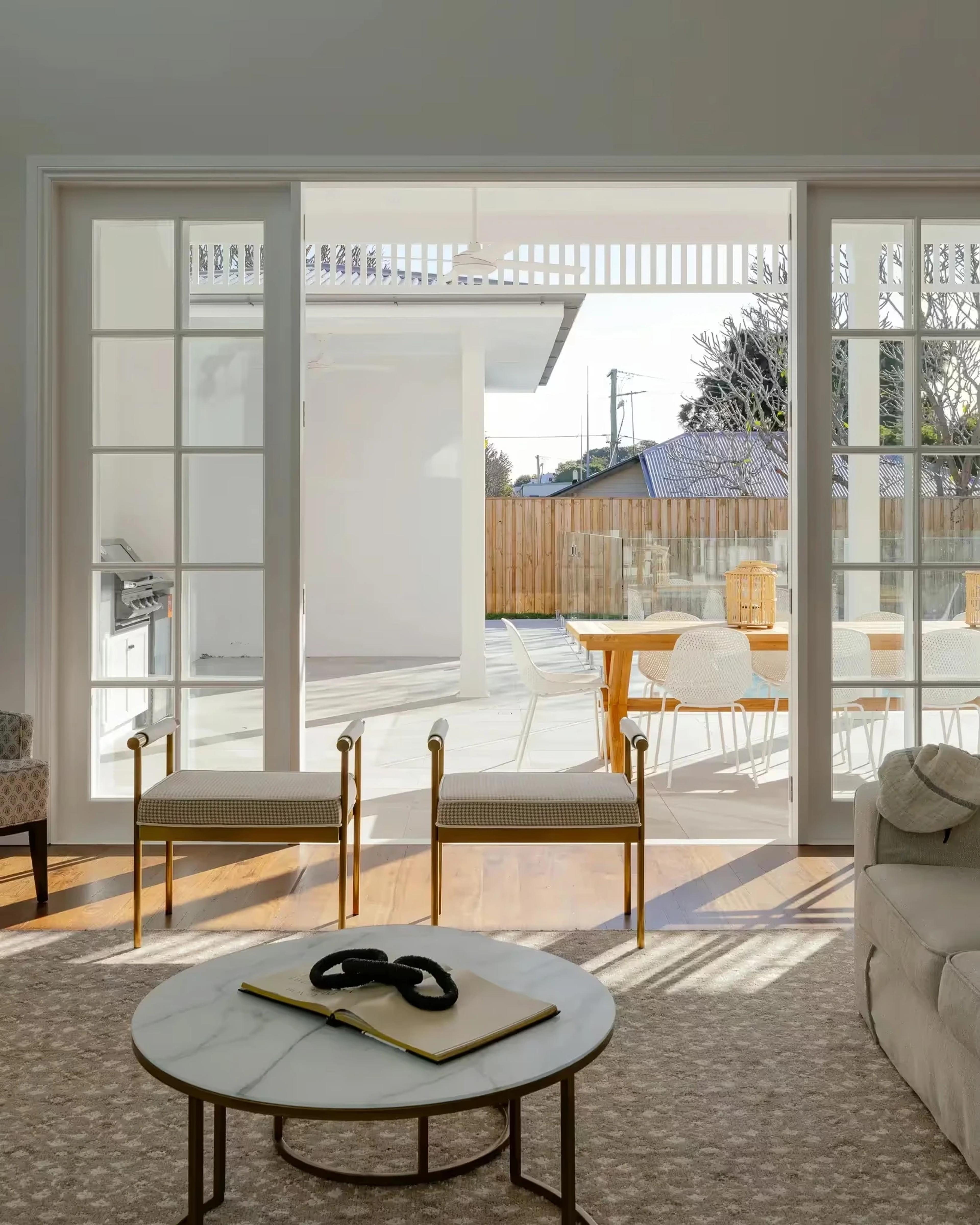 Living room opening to covered outdoor terrace and pool